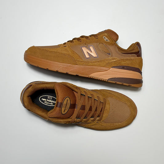 A pair of New Balance Numeric 933 sneakers in a monochromatic brown colorway, featuring suede and mesh panels, a tonal 'N' logo, and matching brown laces, displayed on a light gray background.