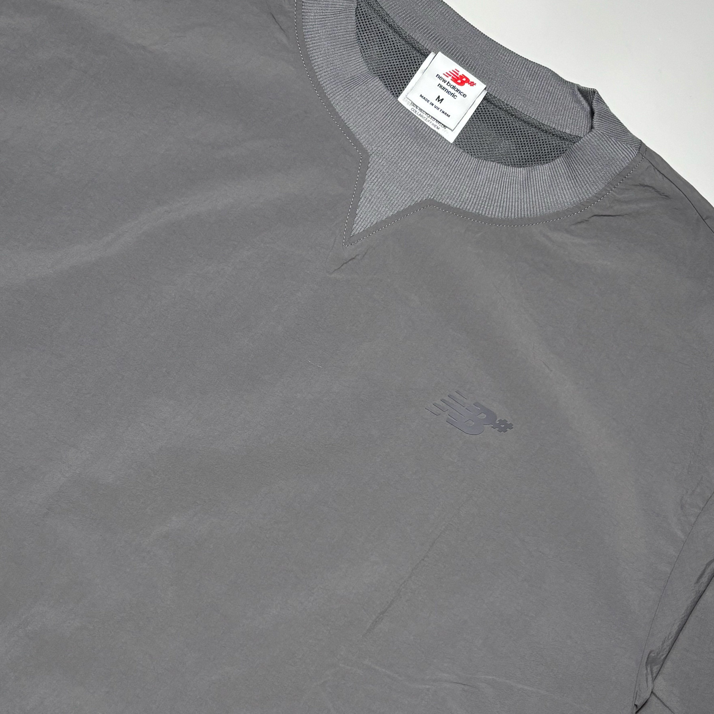 Close detail of rubber NB# logo on chest.