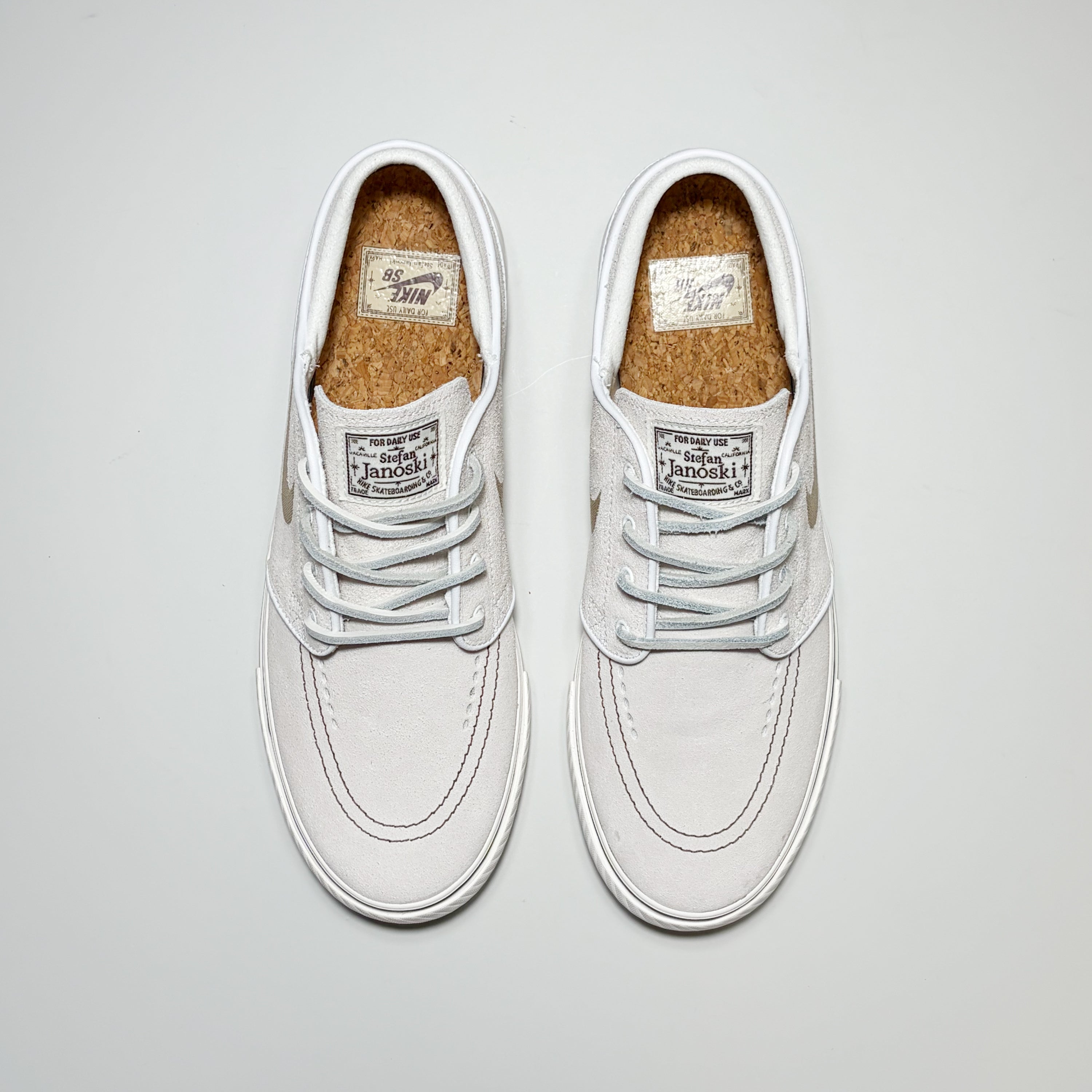 Pair of Nike SB Janoski shoes from a toe down view. Classic leather laces and a cork-textured footbed.