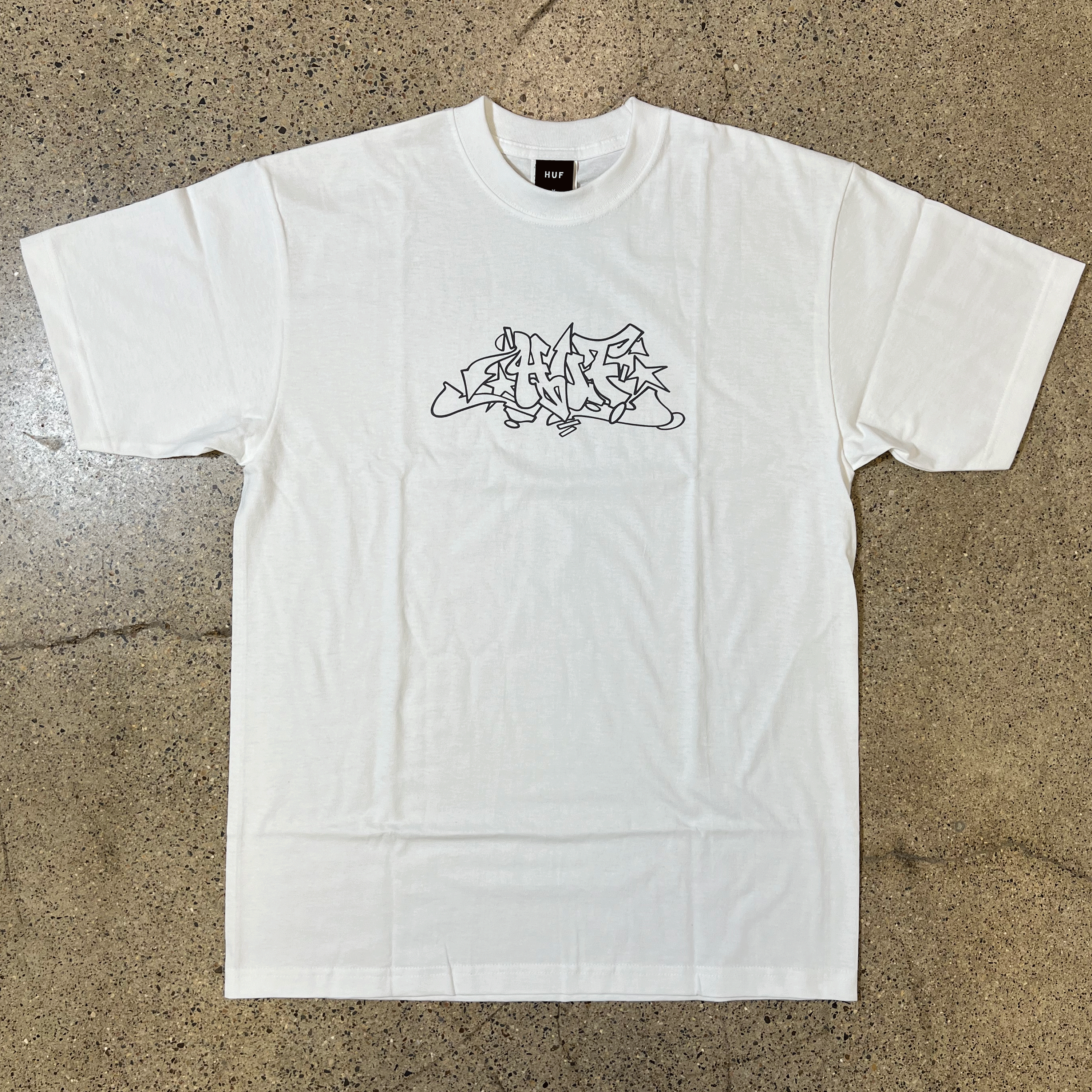 WHITE T-SHIRT, CHEST GRAPHIC OF OUTLINE GRAFFITI THAT READS HUF