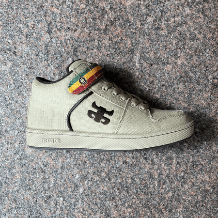 SIDE VIEW OF THE IPATH GRASSHOPPER IN TAN HEMP WITH BROWN EMBROIDERED IPATH LOGO AND GREEN, YELLOW, RED STRIPED TONGUE STRAP 