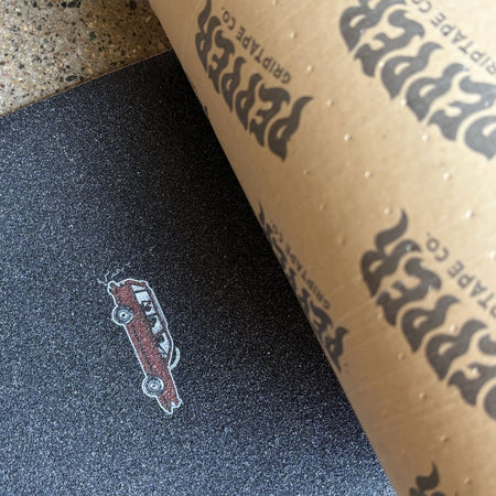 Close detail of Pepper grip with red wagon art printed by tail.