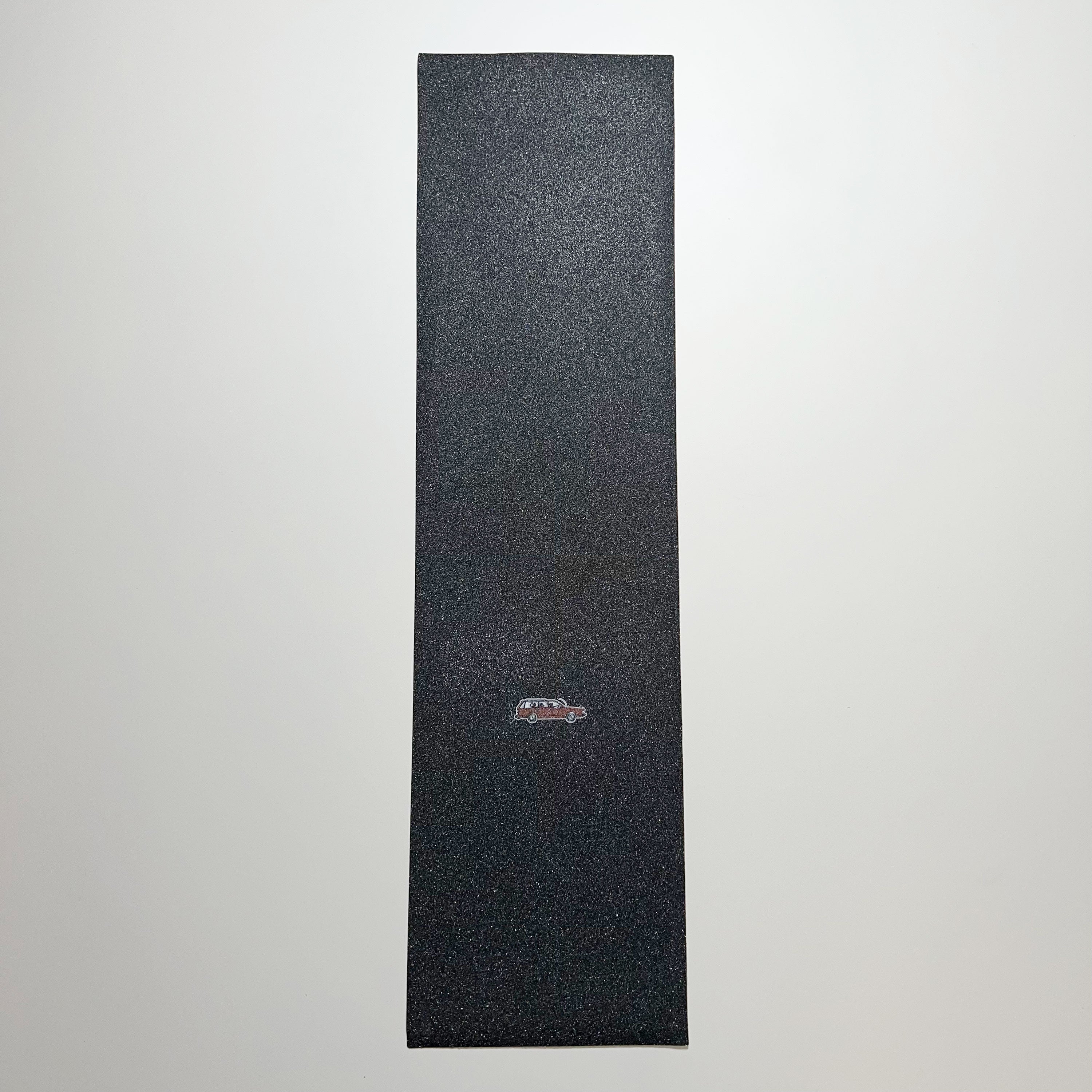 Full image of black griptape with red wagon art by tail