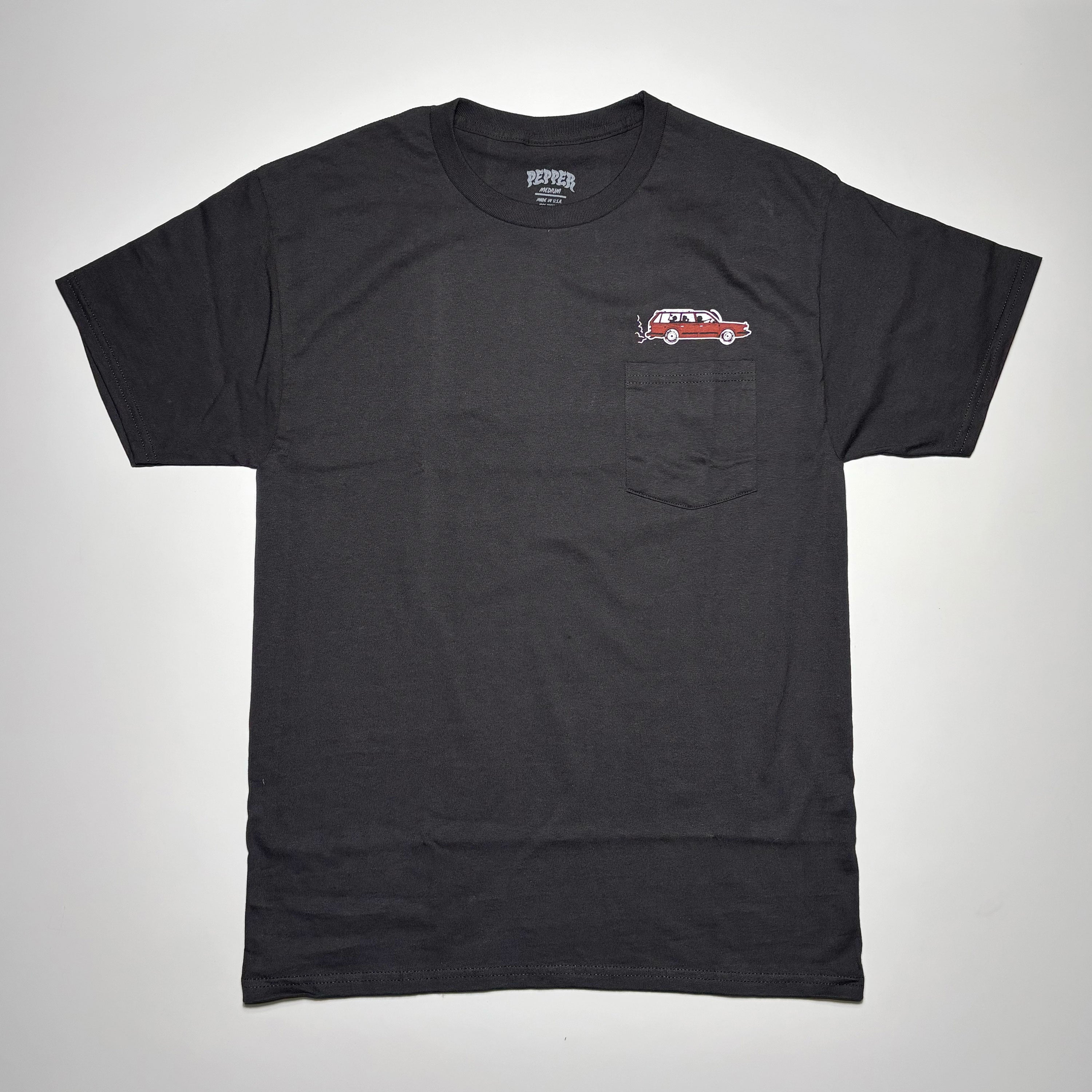 Front image of black pocket tee with red wagon printed on chest above pocket. 