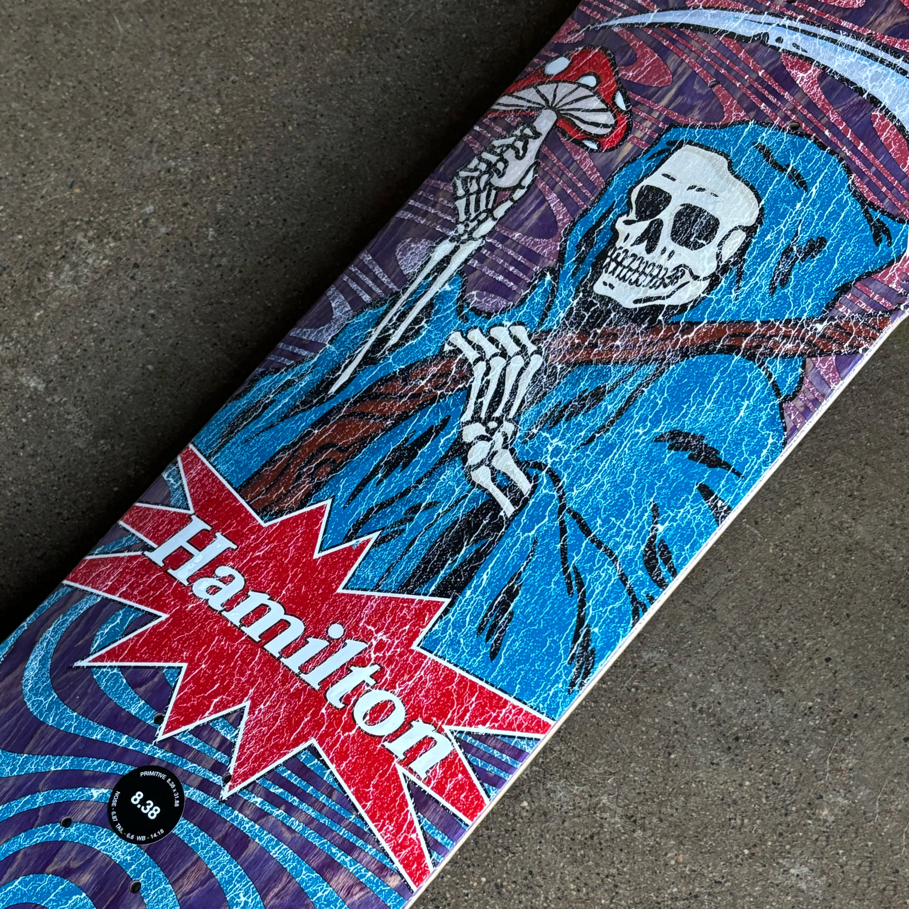 Close detail of reaper art work with distressed layer.