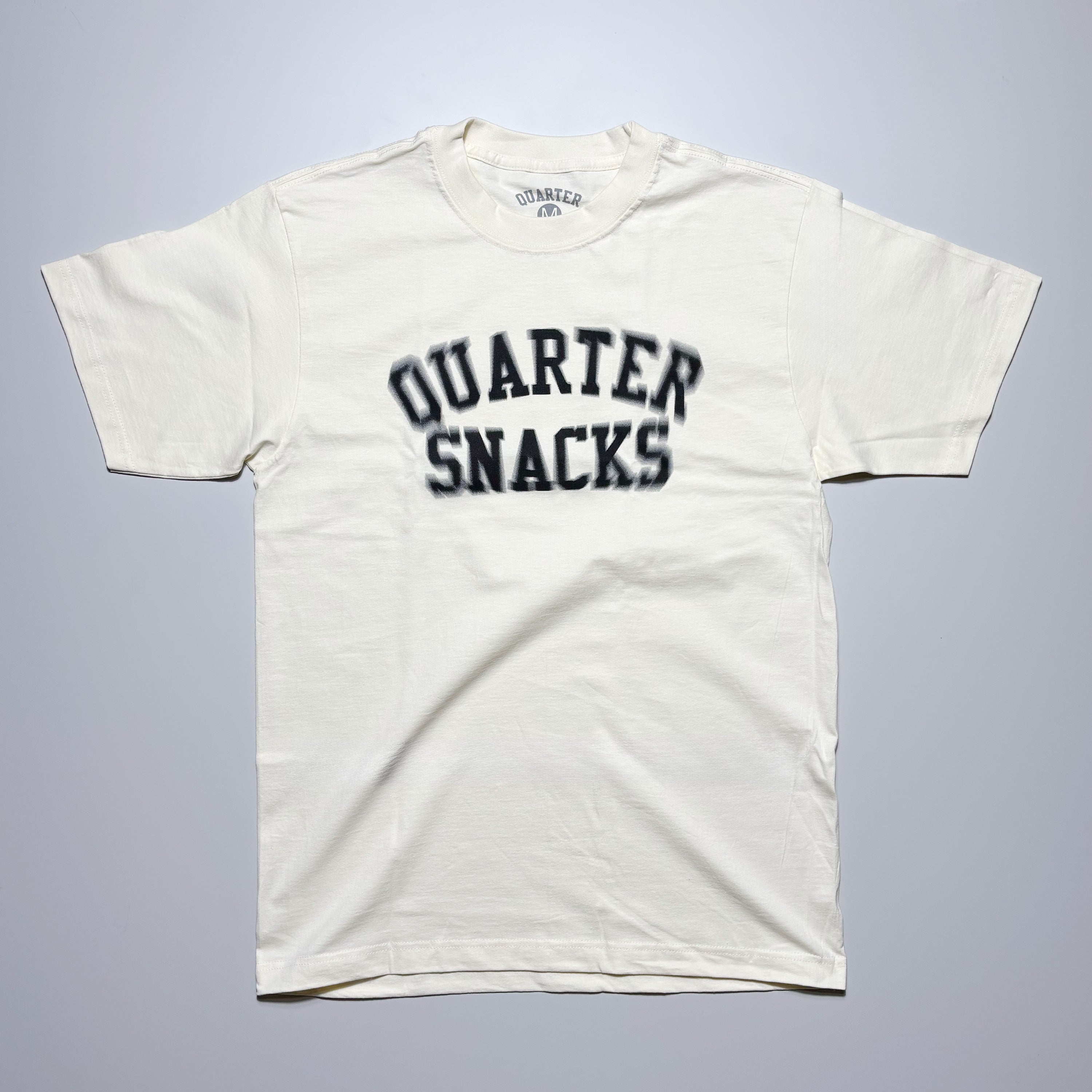 Front image of cream tee with art printed on chest.