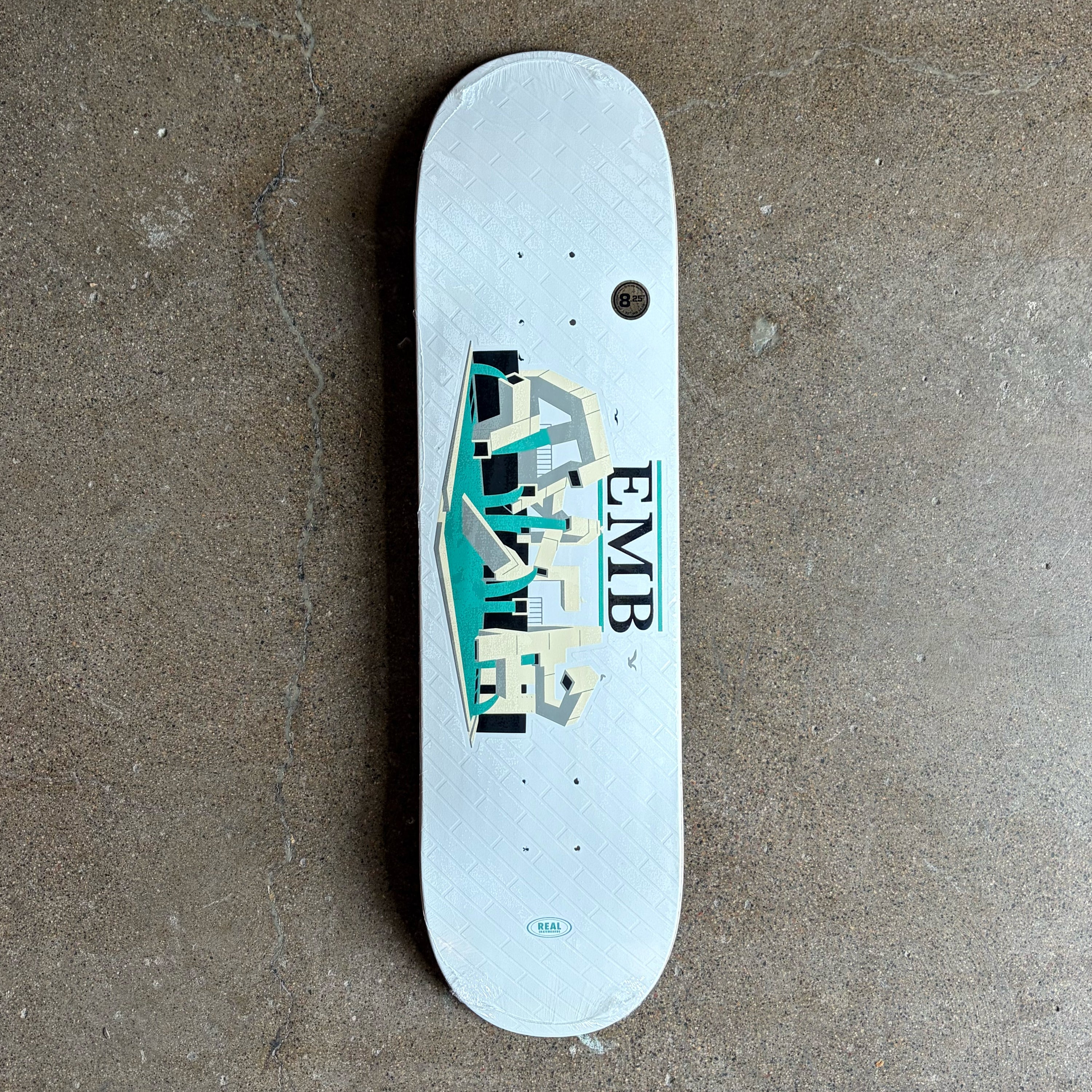 Full image of Real Skateboards EMB tribute deck. Brick texture and art from the embarcadero plaza in SF.