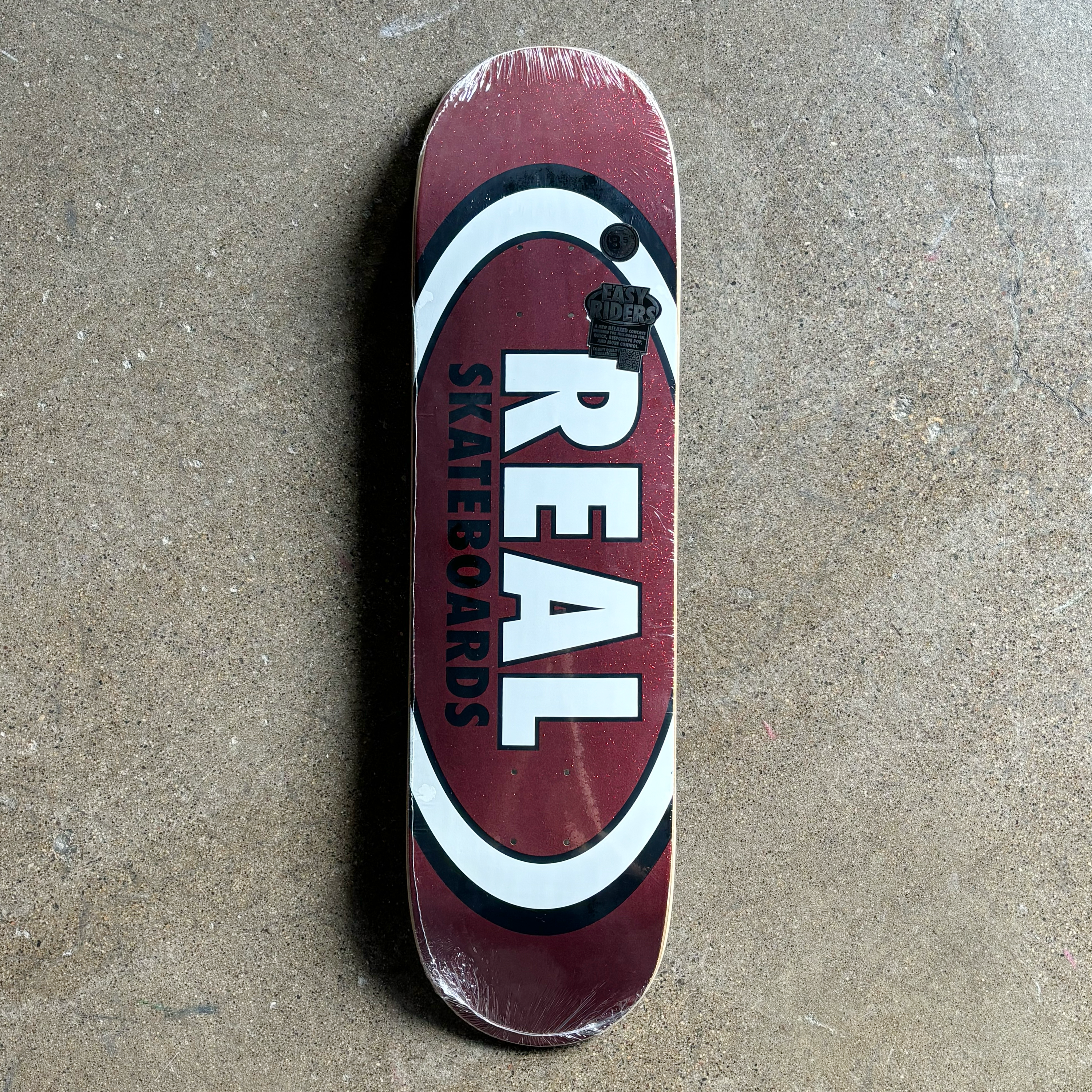 IMAGE OF RED GLITTER BACKGROUND WITH REAL SKATEBOARDS FONT OUTLINED IN BLACK