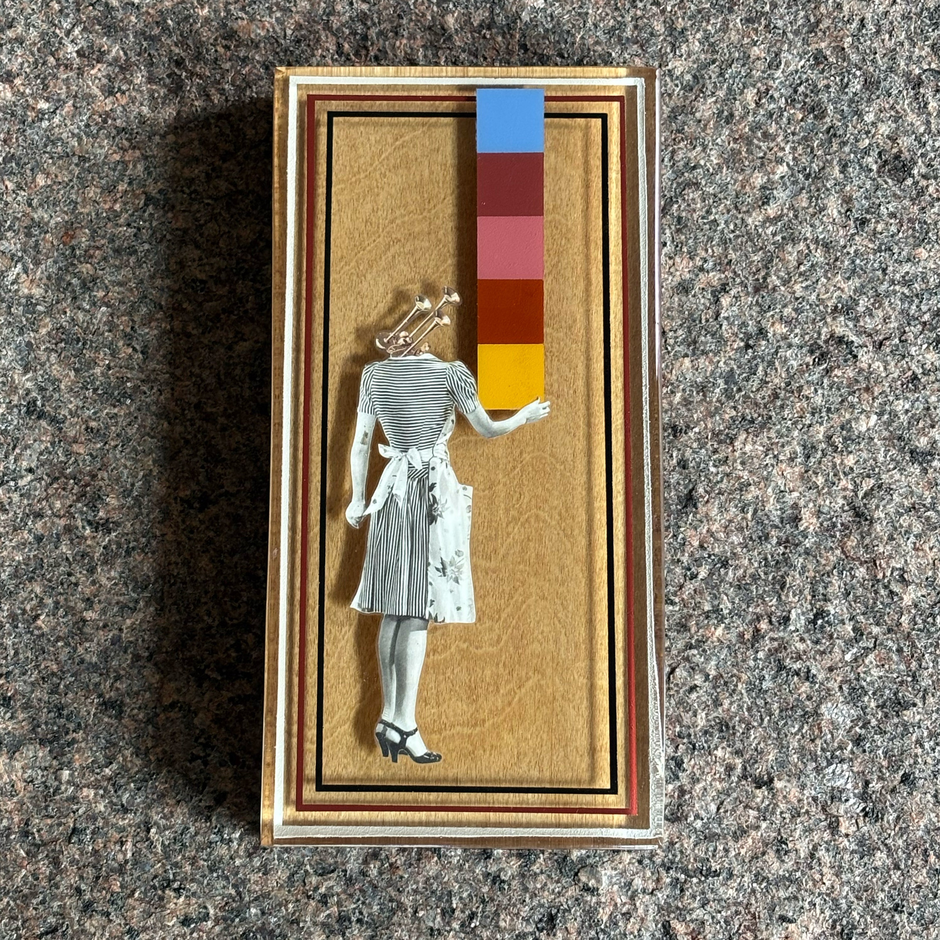 Collage artwork layered in custom epoxy resin frame. 