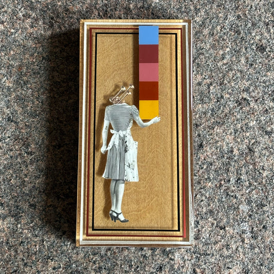 Collage artwork layered in custom epoxy resin frame. 