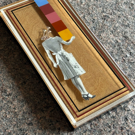 Close detail of layered collage artwork. Custom frame handmade with epoxy resin.