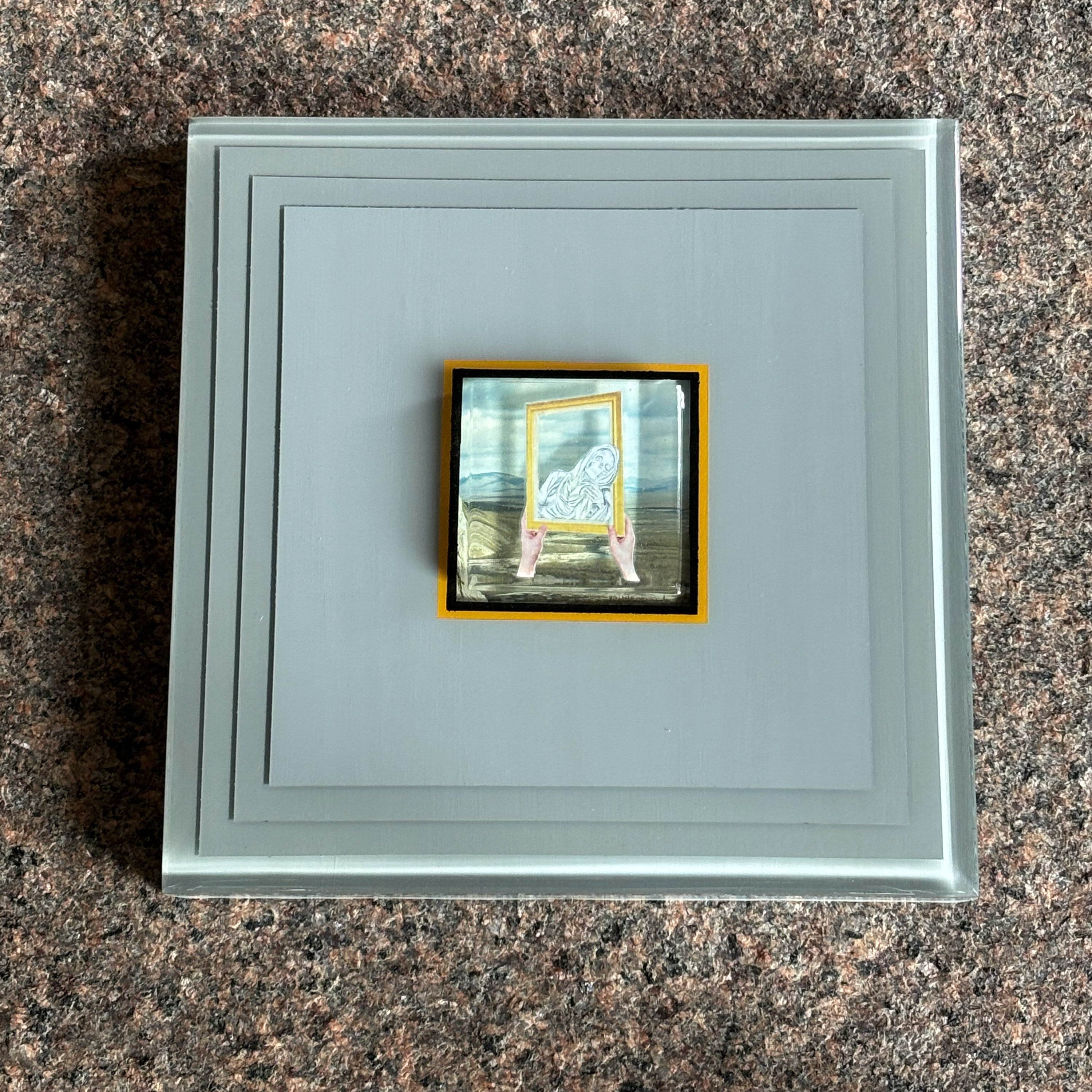 Framed image of 3D layered collage artwork with custom epoxy resin.