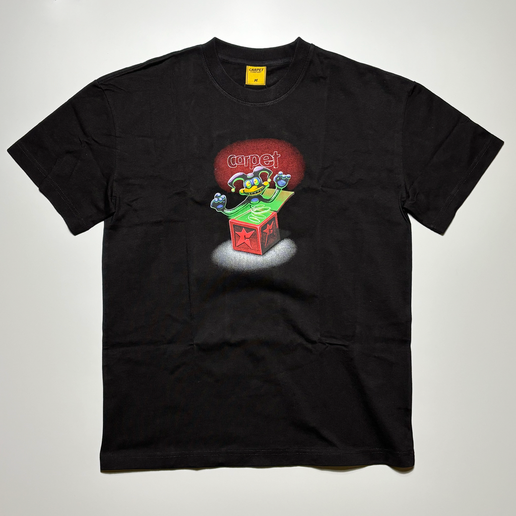 Full image of black tee.
Printed jack in the box art on chest.