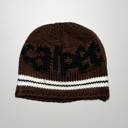 Full image of brown knitted beanie.
Carpet in black knit across the top