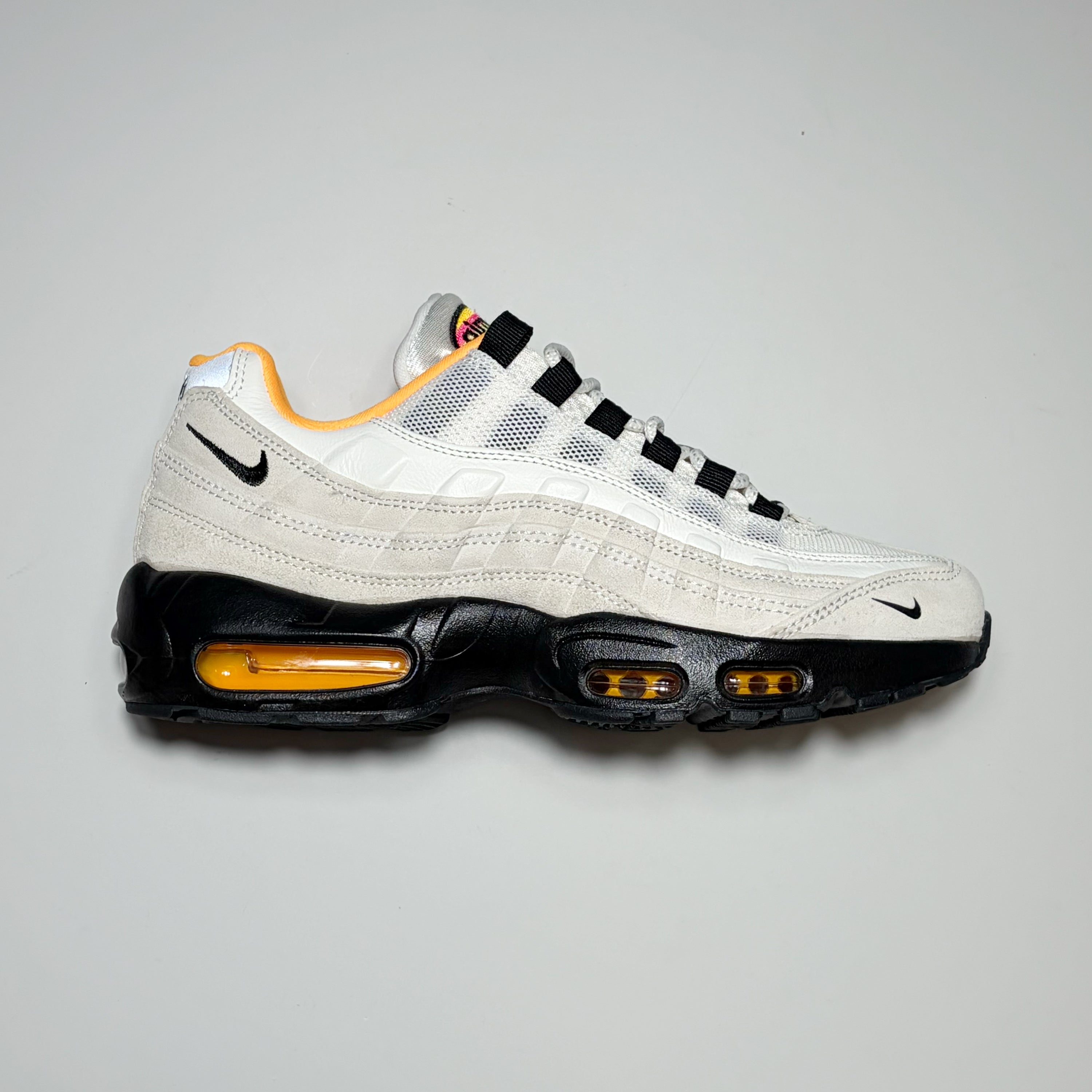 Right side image, Nike SB Air Max 95 shoe. Cream suede with black mid-sole.