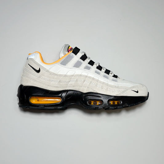 Right side image, Nike SB Air Max 95 shoe. Cream suede with black mid-sole.