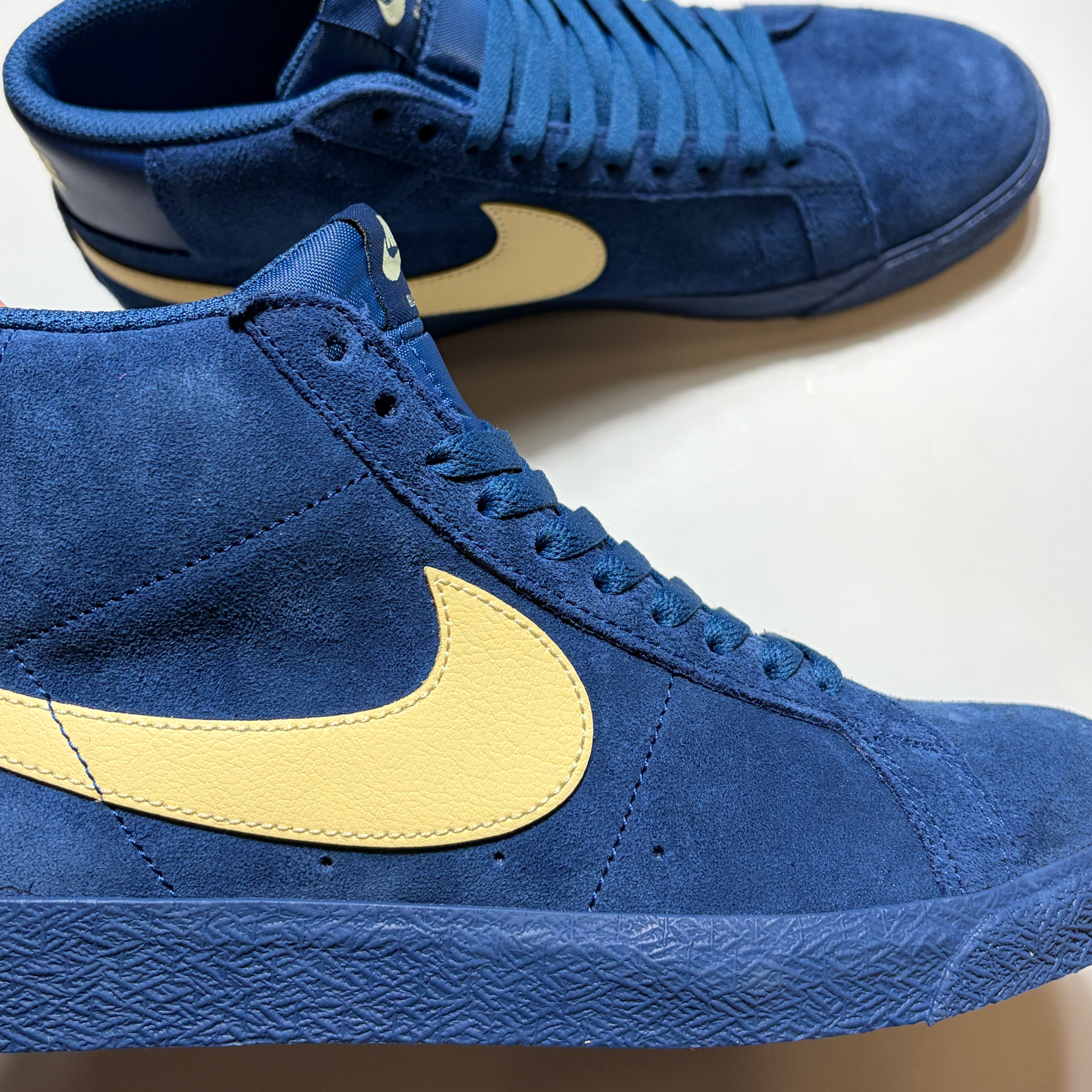 Close detail of blue suede Nike SB Zoom Blazer Mid with pale yellow swoosh.