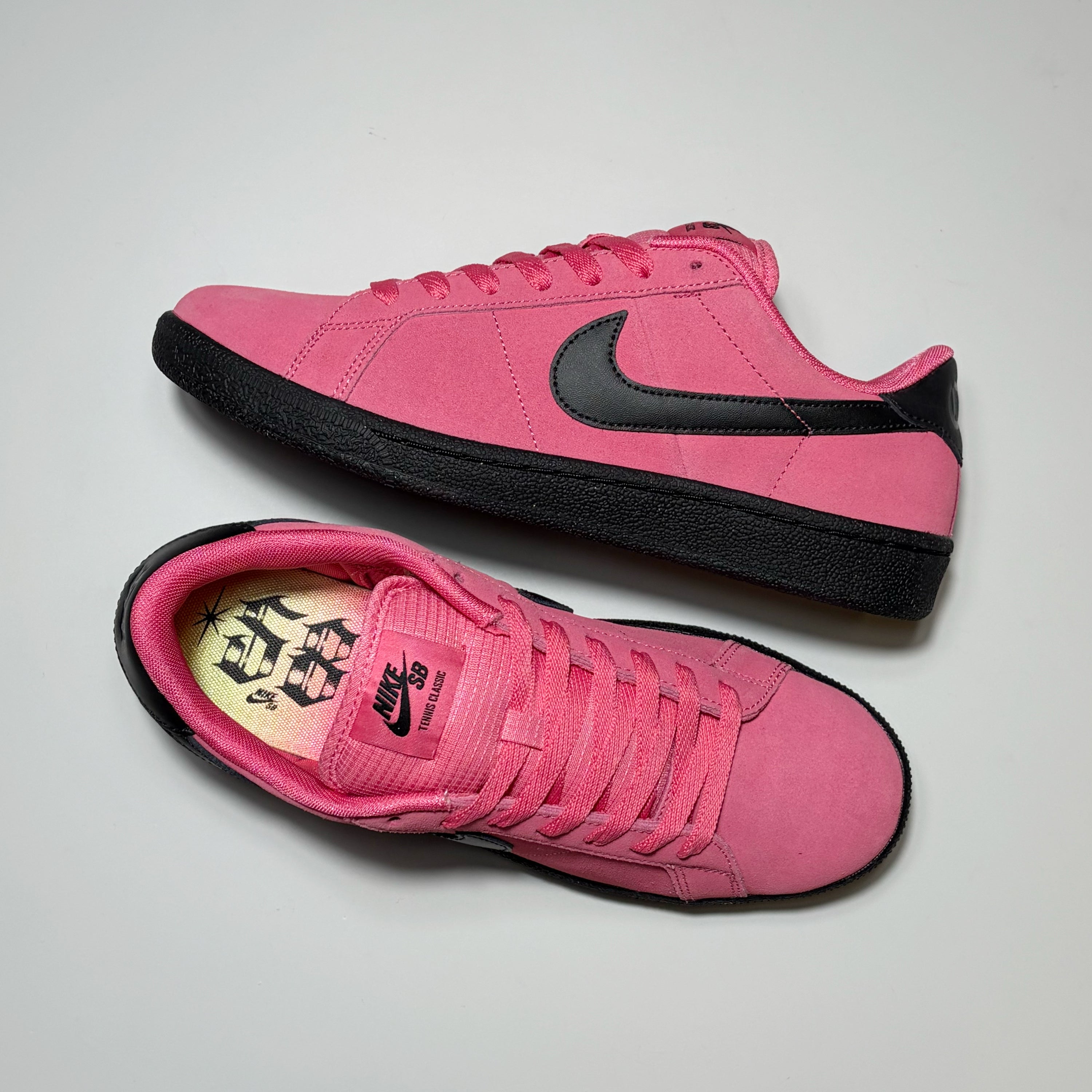 Paid of Nike SB Zoom Tennis Classic shoes. 1 side view and other toe down.