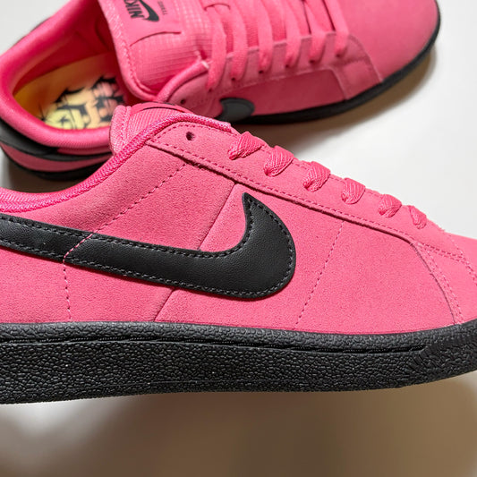 Close detail of black swoosh on hyper pink suede.