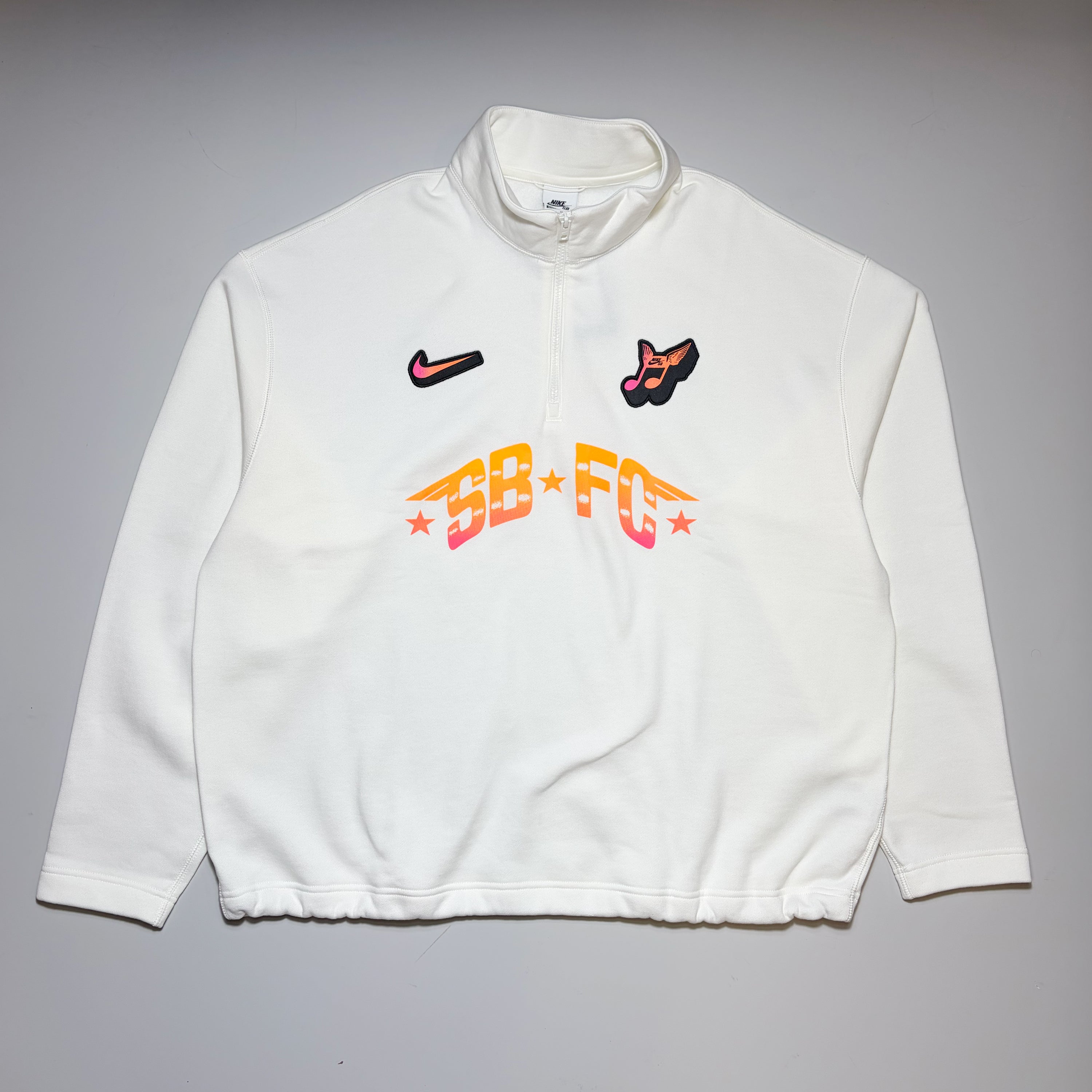 Full front image of Nike SB FC 1/2 zip crew sweatshirt. White fleece with printed art on front.