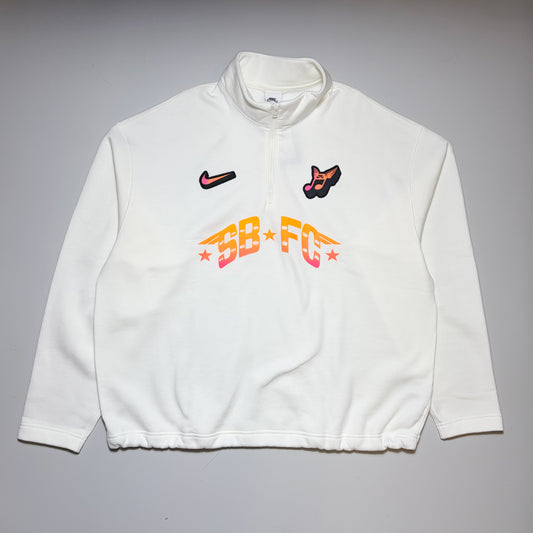 Full front image of Nike SB FC 1/2 zip crew sweatshirt. White fleece with printed art on front.