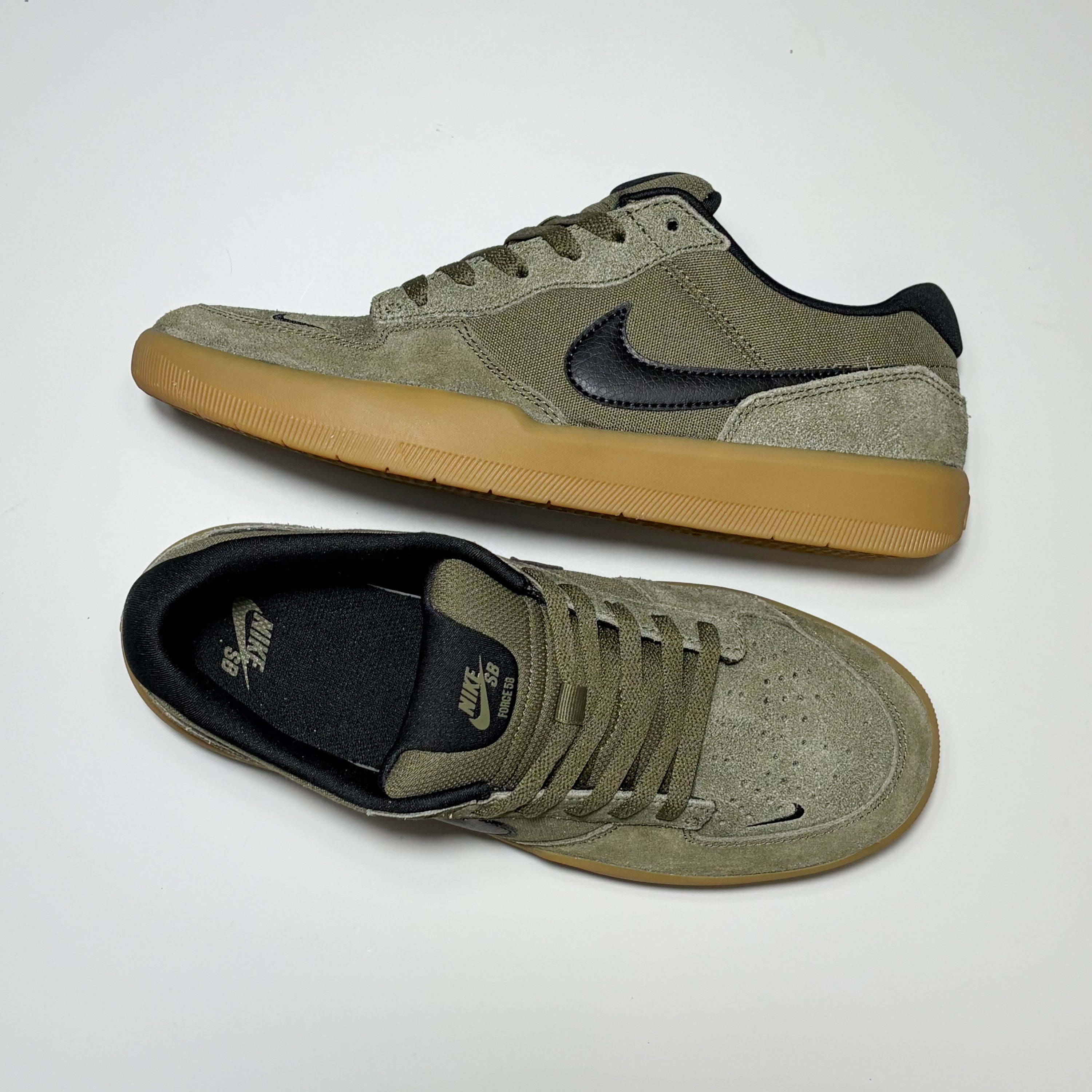Pair of Nike SB Force 58 in olive suede on a white background.