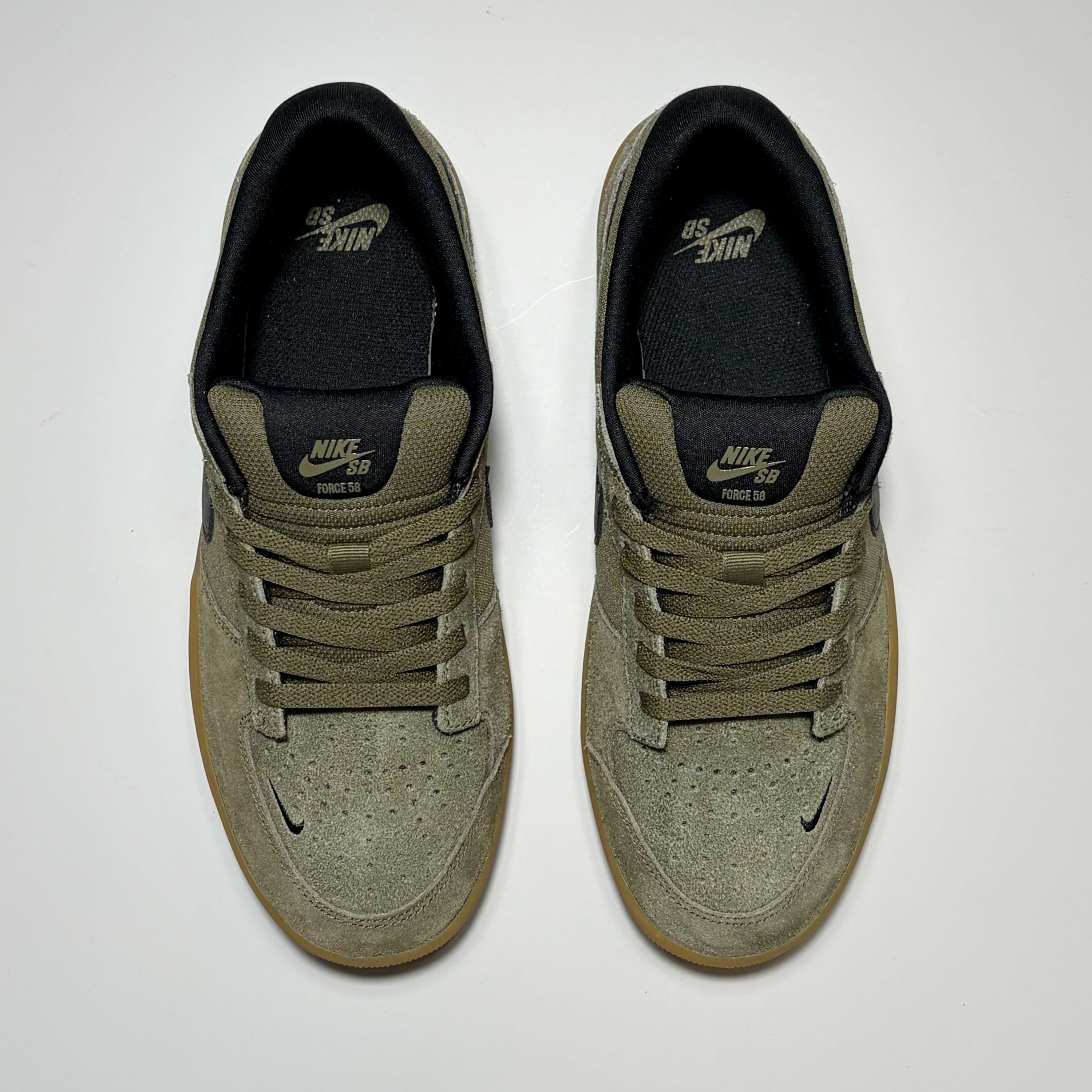 Toe down view of both pairs. Nike Force 58 shoes. Olive suede with black contrast details. 