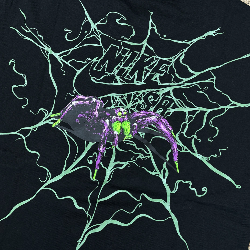 Close detail of spider printed art on back of tee. Glow in the dark ink for spider web and fur.