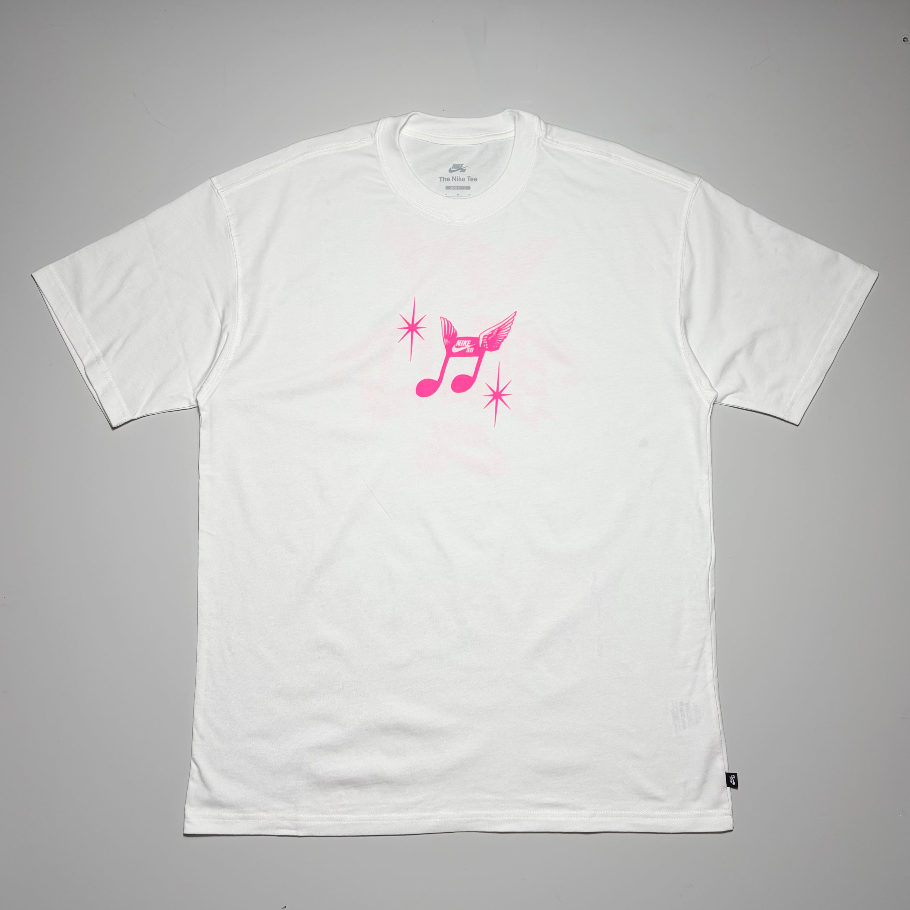 Full front image of white Nike SB FC WC tee. Pink printed art on front.