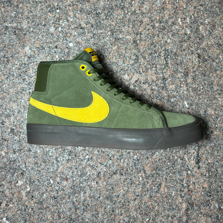 Side image of right shoe.
Olive green with dark gum sole and yellow swoosh.