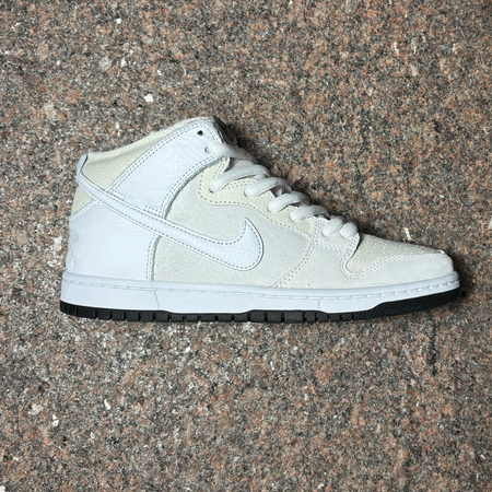 Side image of right shoe. White leather with white suede and white swoosh.