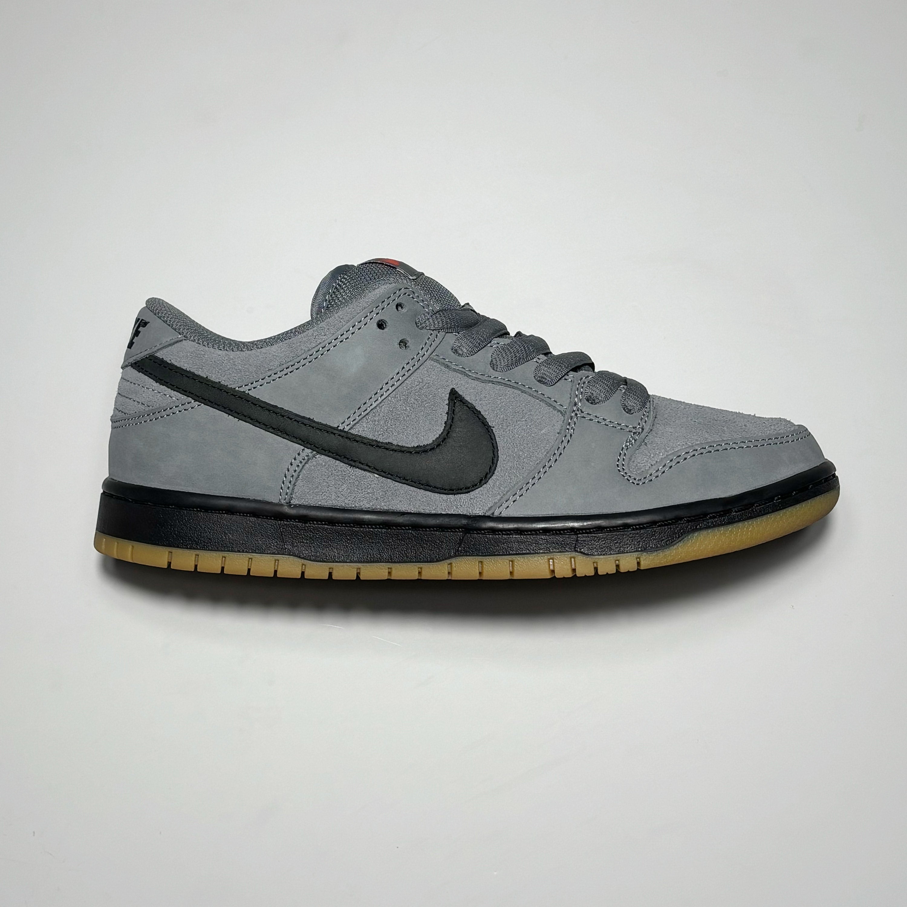 Side image of right shoe. Grey nubuck and suede with black midsole and swoosh.