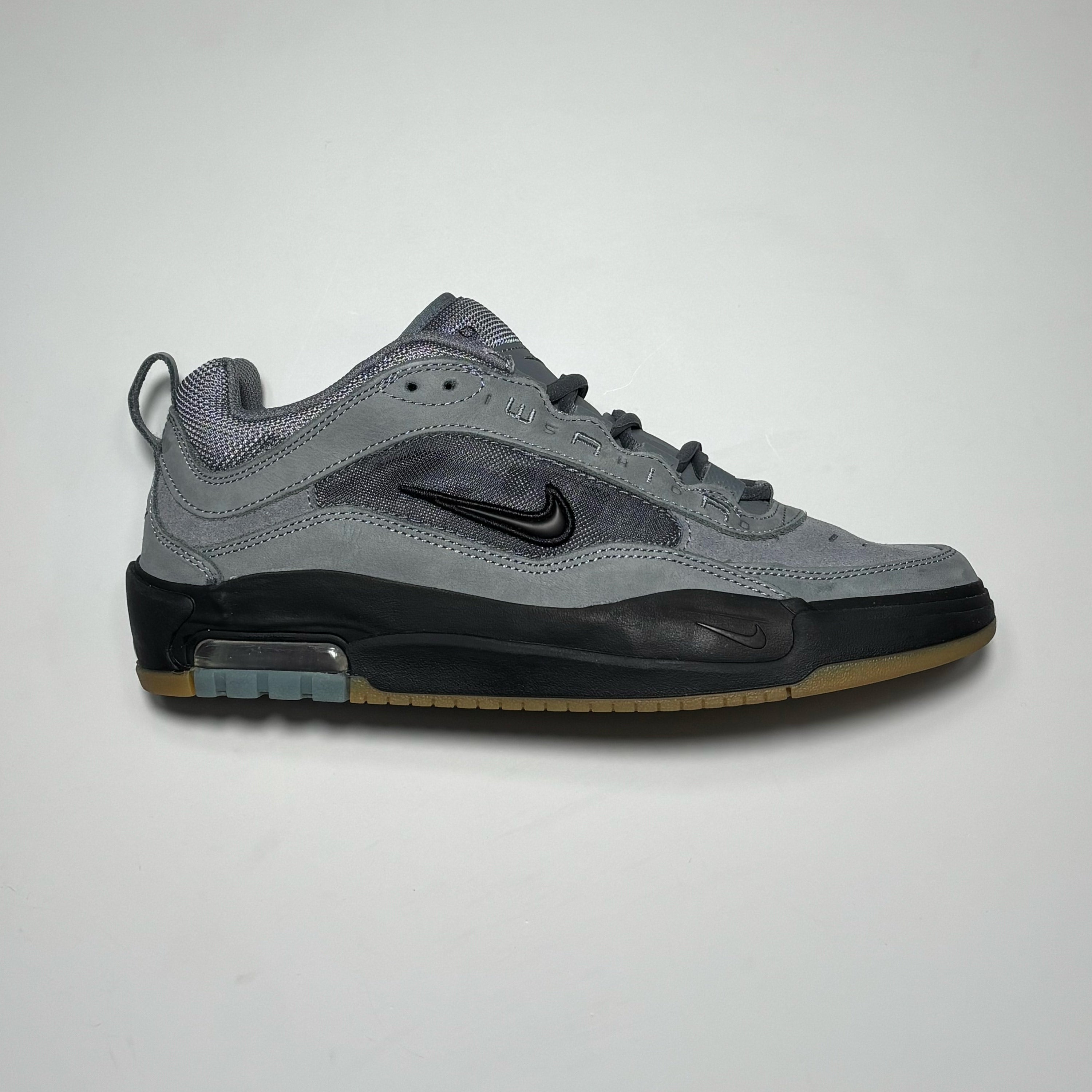 Side image of right shoe.
Grey suede with black outsole and black swoosh.