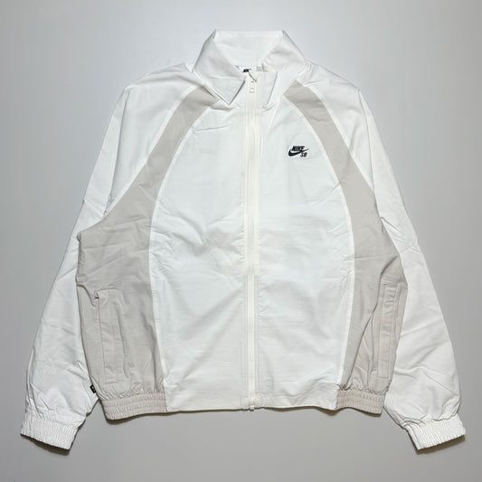 Front image of white/bone color blocked track jacket with full zip and nike sb logo embroidered on chest