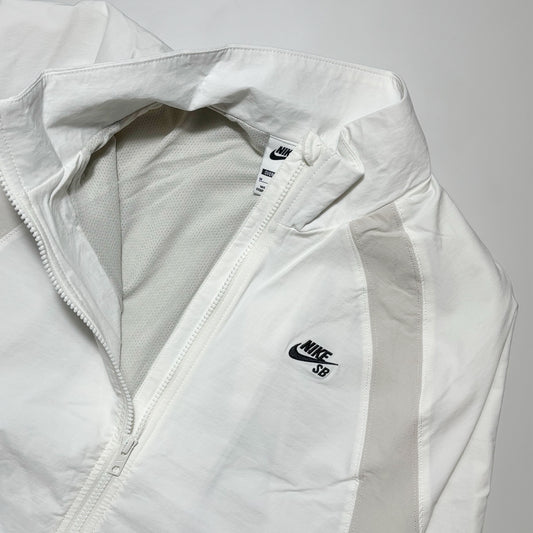Close detail of embroidery on chest. Mesh lined woven jacket.