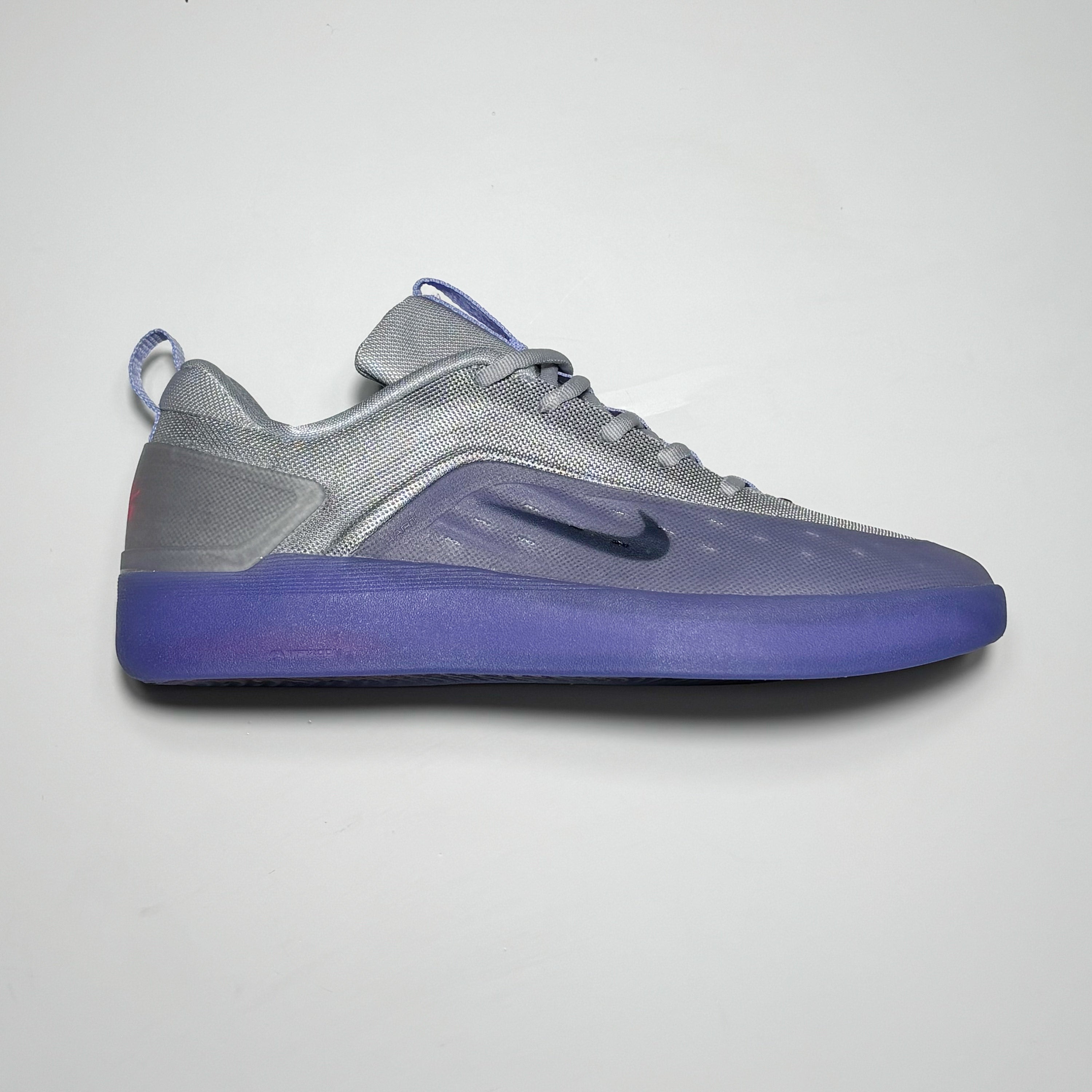 Side image of right shoe.
Grey synthetic mesh with purple tinted high abrasion rubber around toe.