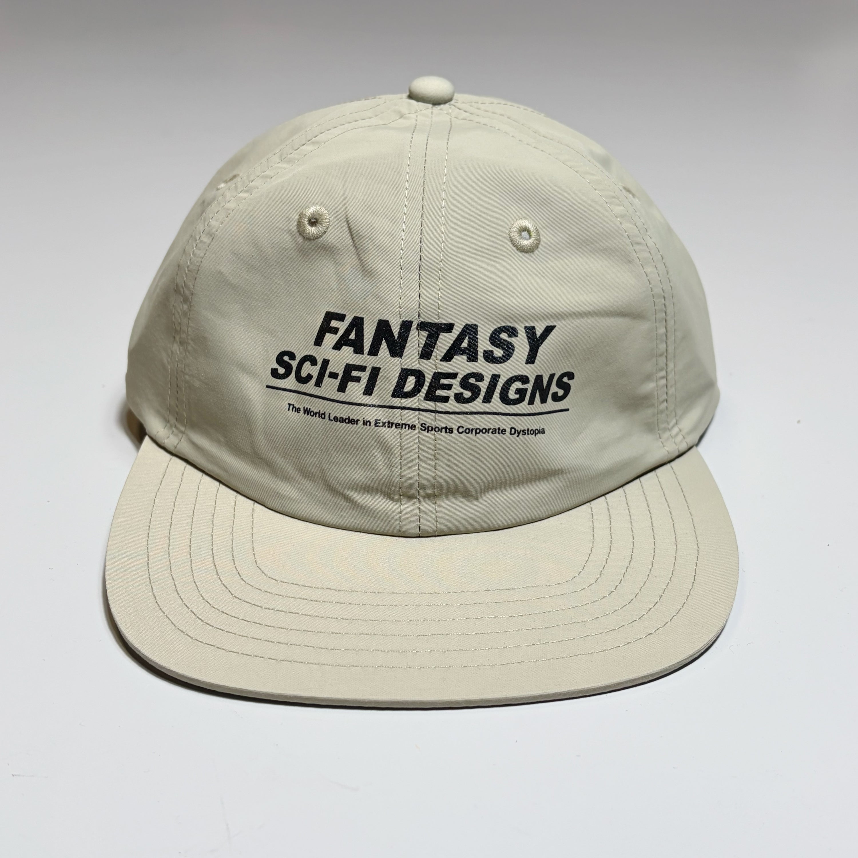 Front image of light tan nylon Sci-Fi Fantasy hat. Black text printed on crown.