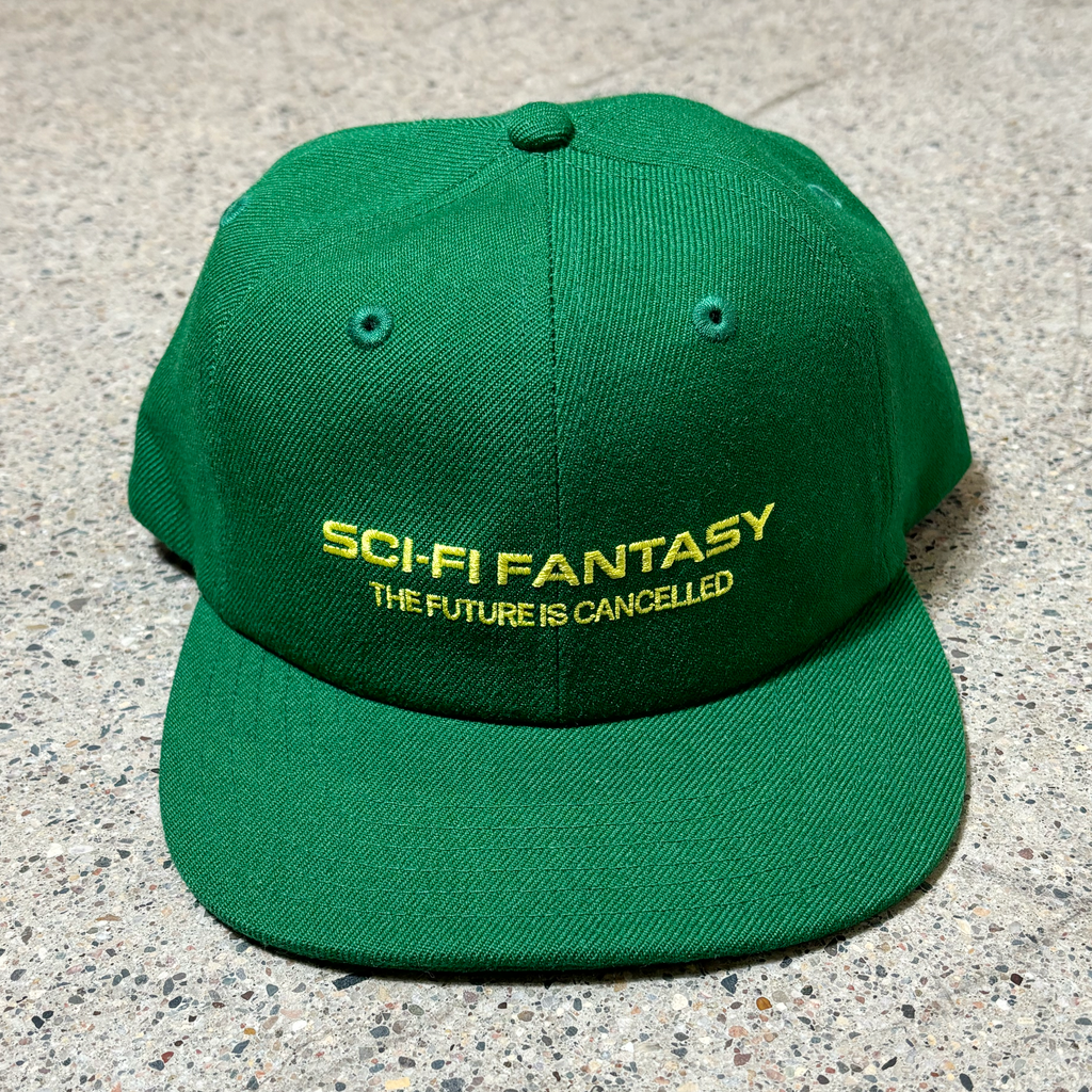 Front image of green hat with text embroidered on crown