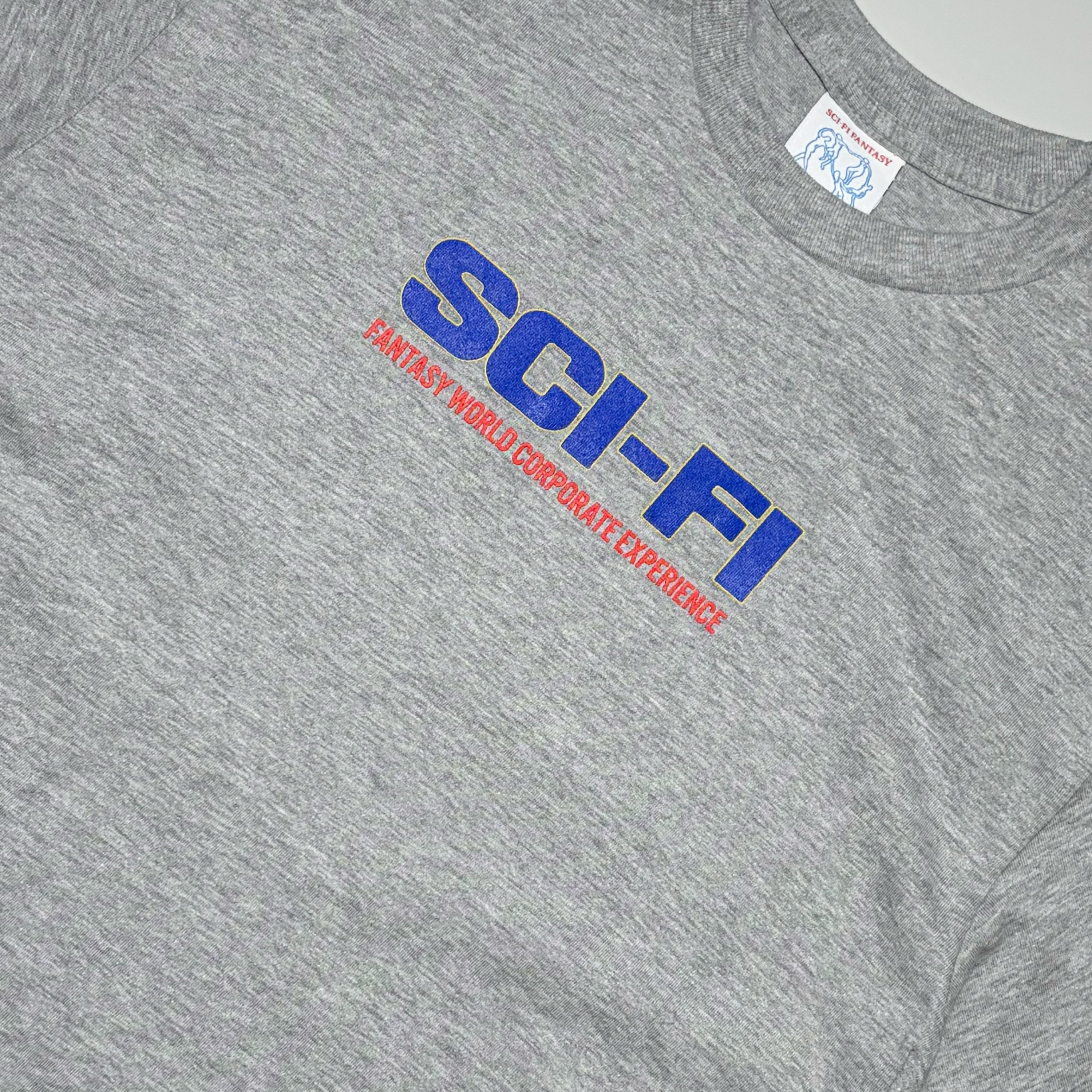 Close detail of Sci-Fi printed text in blue with red text underneath.