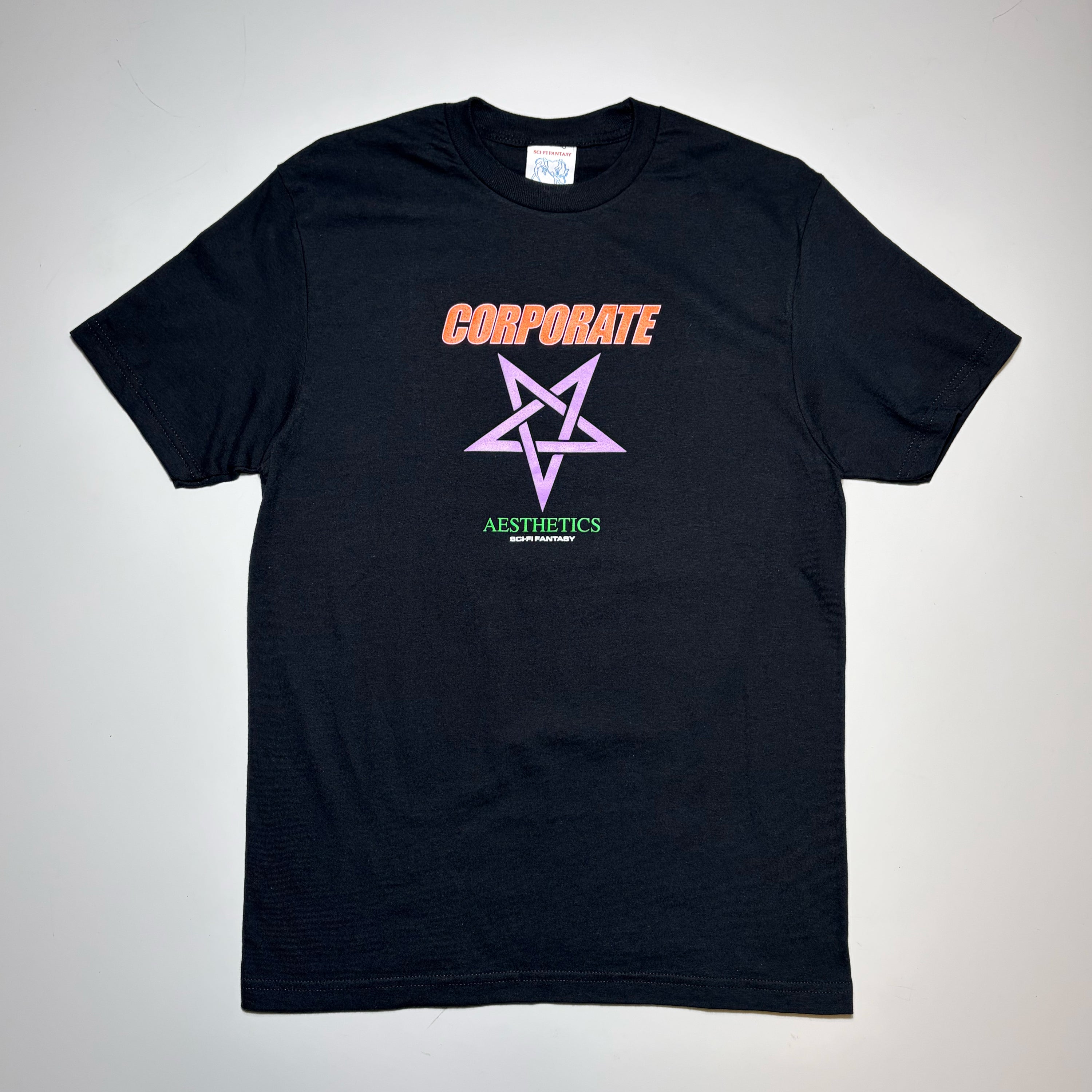 Front image of black tee with text printed in orange and green. Purple star art on chest.