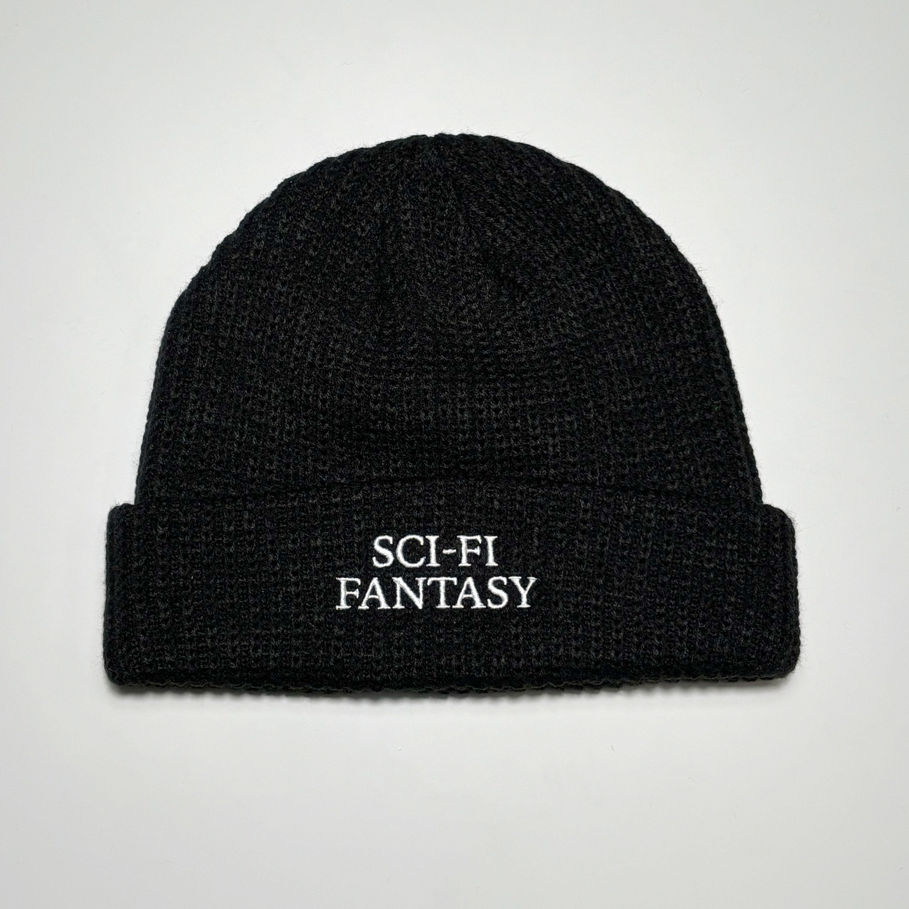 Full image of black beanie with sci-fi fantasy embroidered logo.