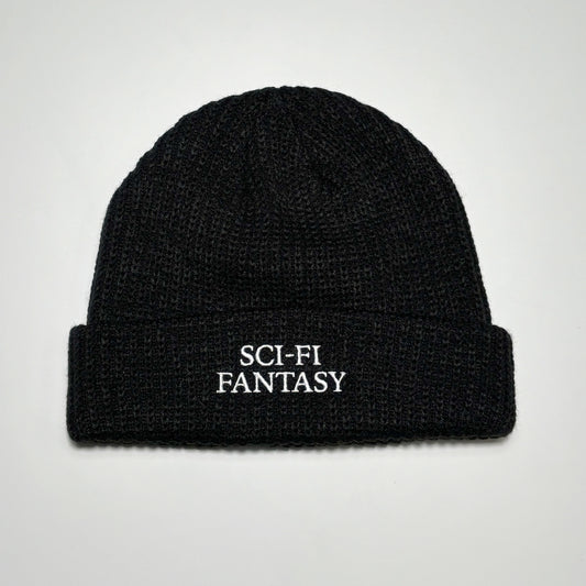 Full image of black beanie with sci-fi fantasy embroidered logo.