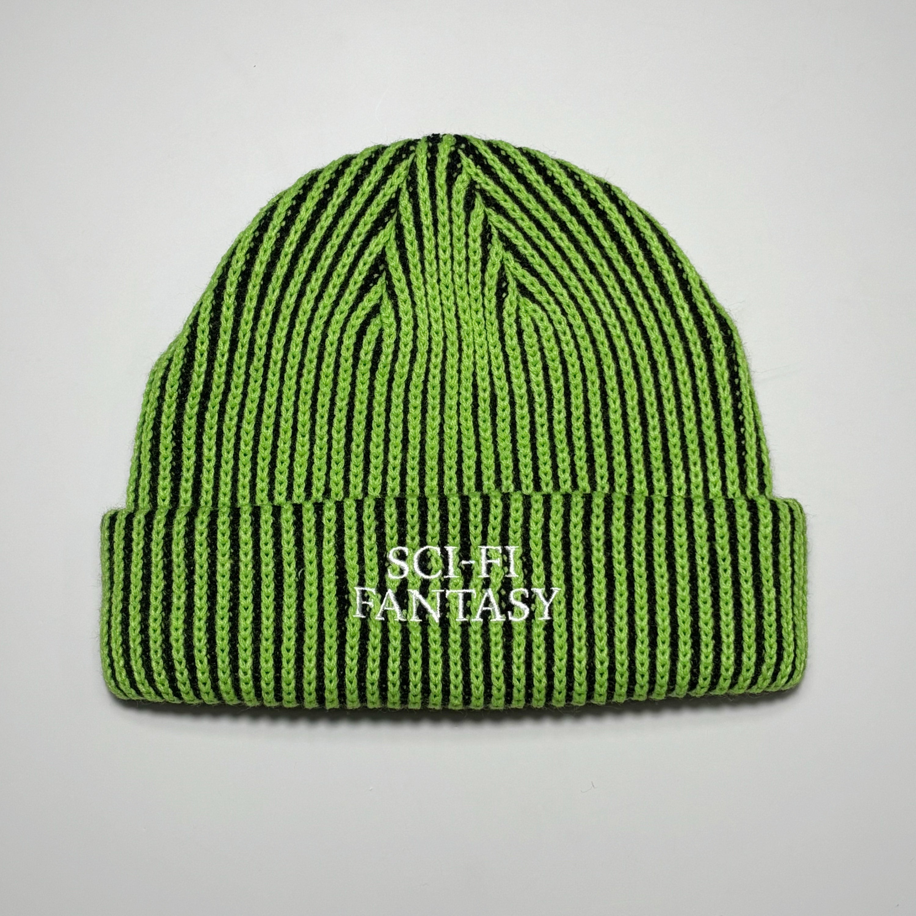 Full image of green/black vertical striped beanie with sci-fi fantasy embroidered logo.