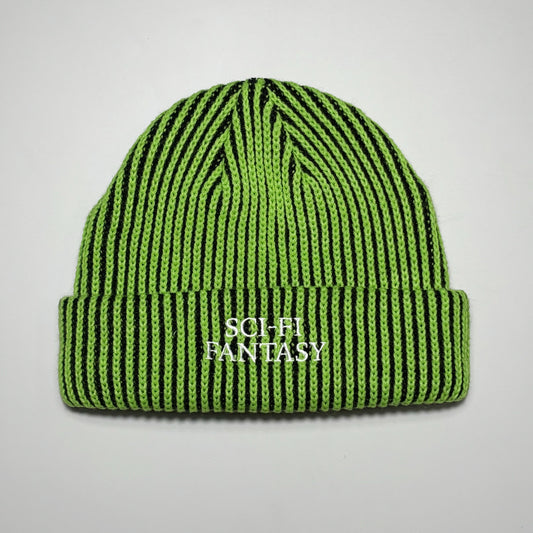 Full image of green/black vertical striped beanie with sci-fi fantasy embroidered logo.