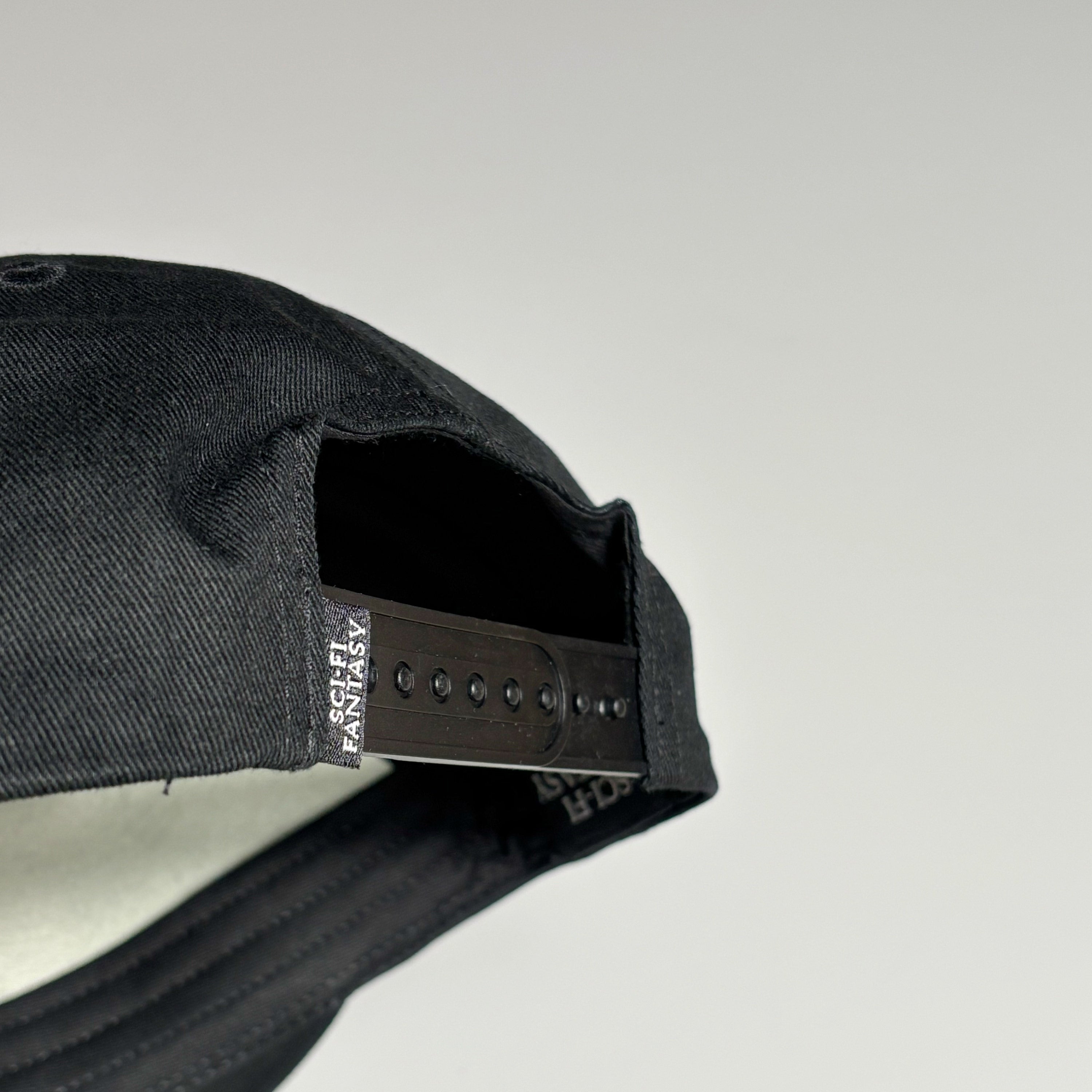 Back detail snapback closure and sci-fi label.