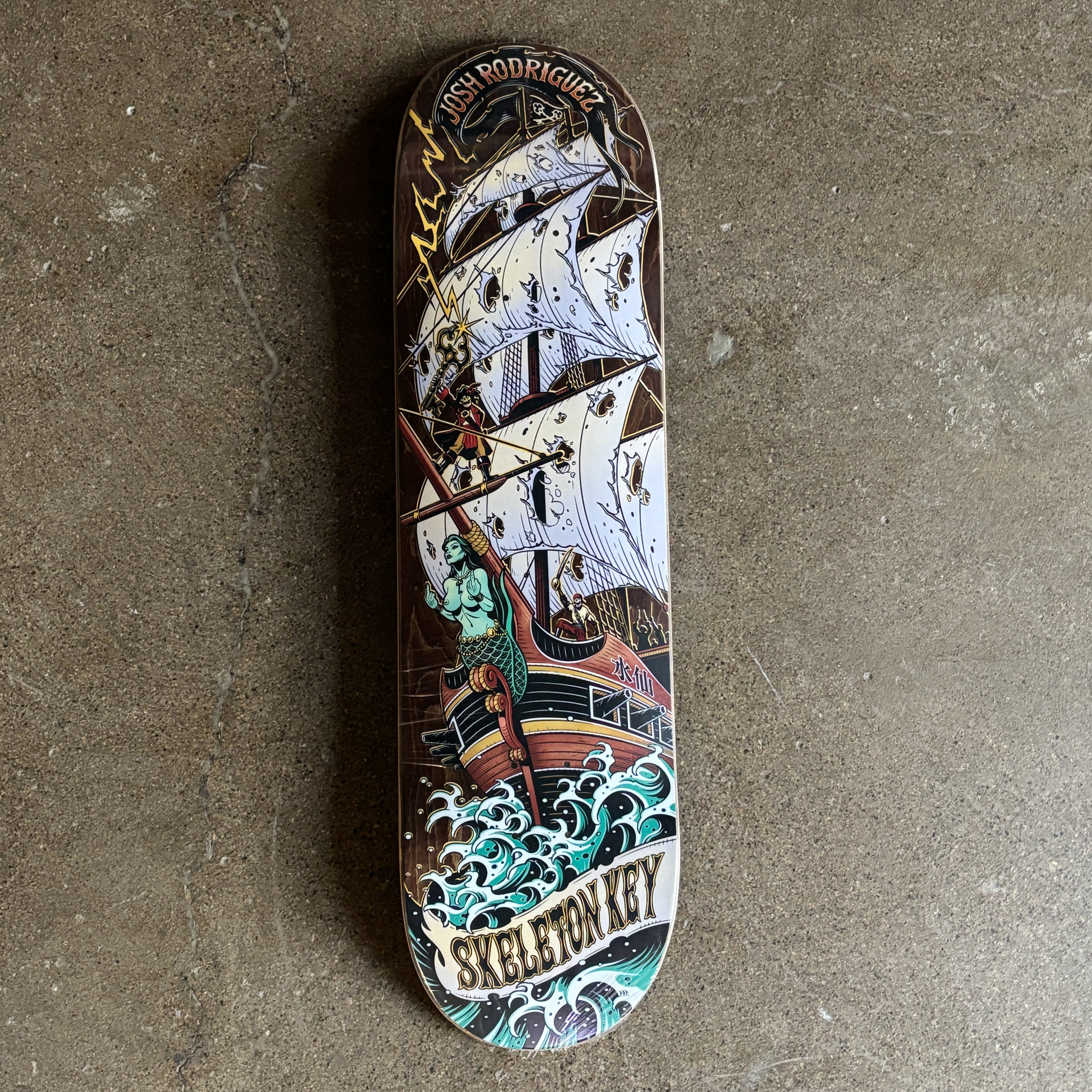 Full image of deck. Pirate ship art across top to bottom.