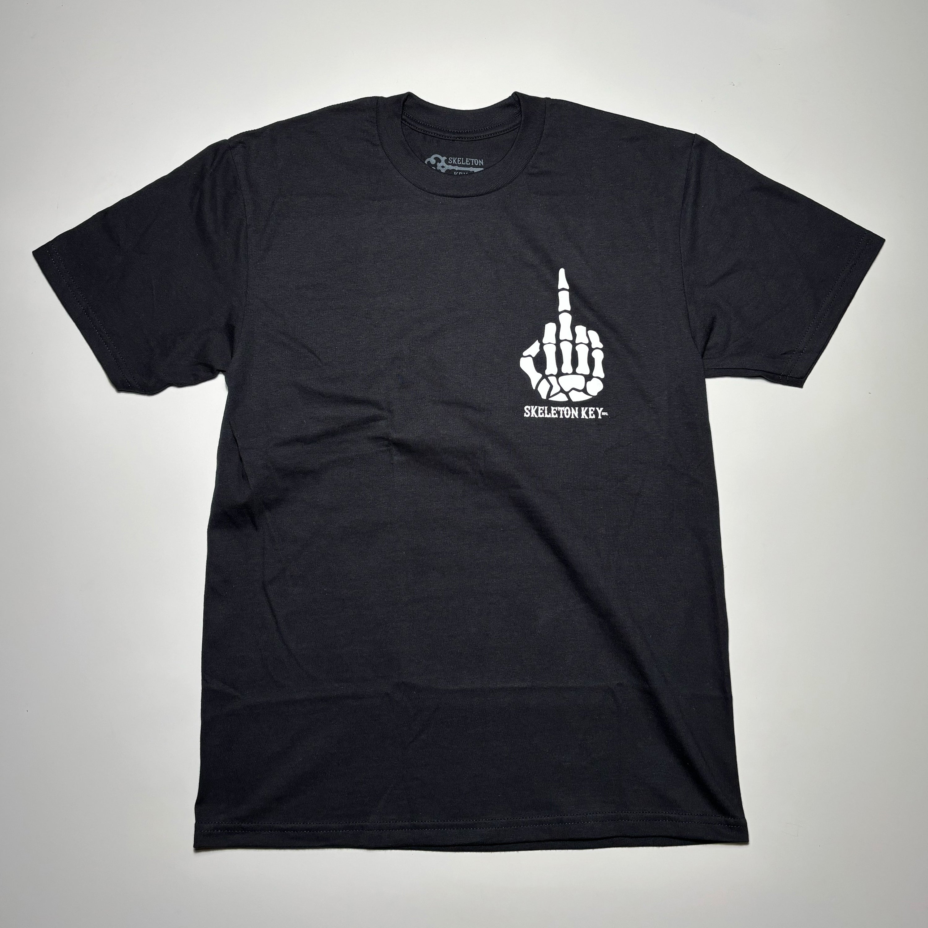 Full image of black tee with white printed art on chest.