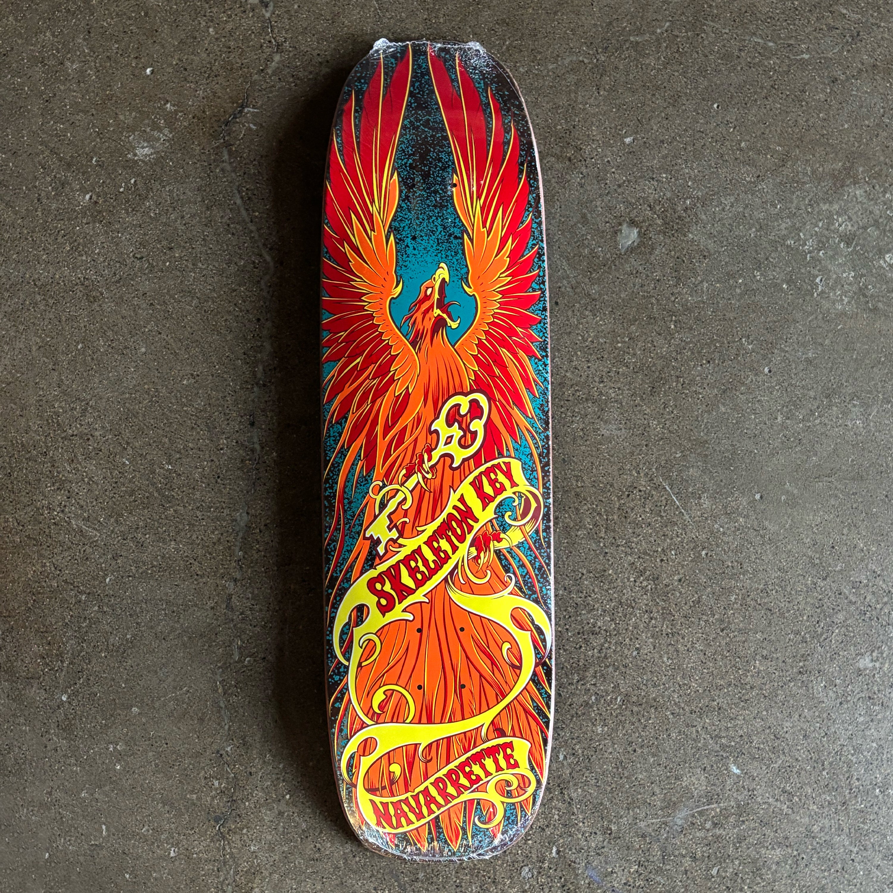 Full image of deck with orange phoenix art from top to bottom.