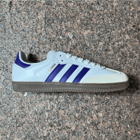 ADIDAS SKATEBOARDING SAMBA ADV IN WHITE LEATHER, TOE SUEDE,  PURPLE STRIPES AND BROWN GUM SOLE DISPLAYED ON GRANITE