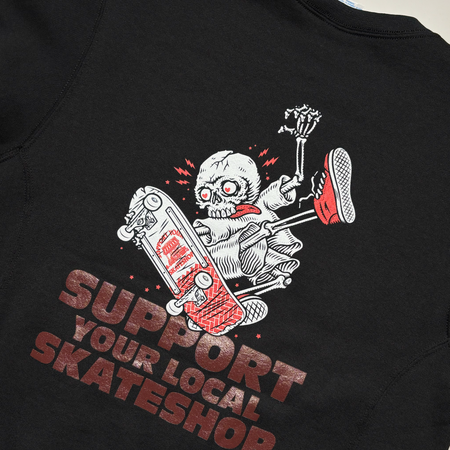 Close detail of skeleton drawing in white with maroon "support your local" printed on back.